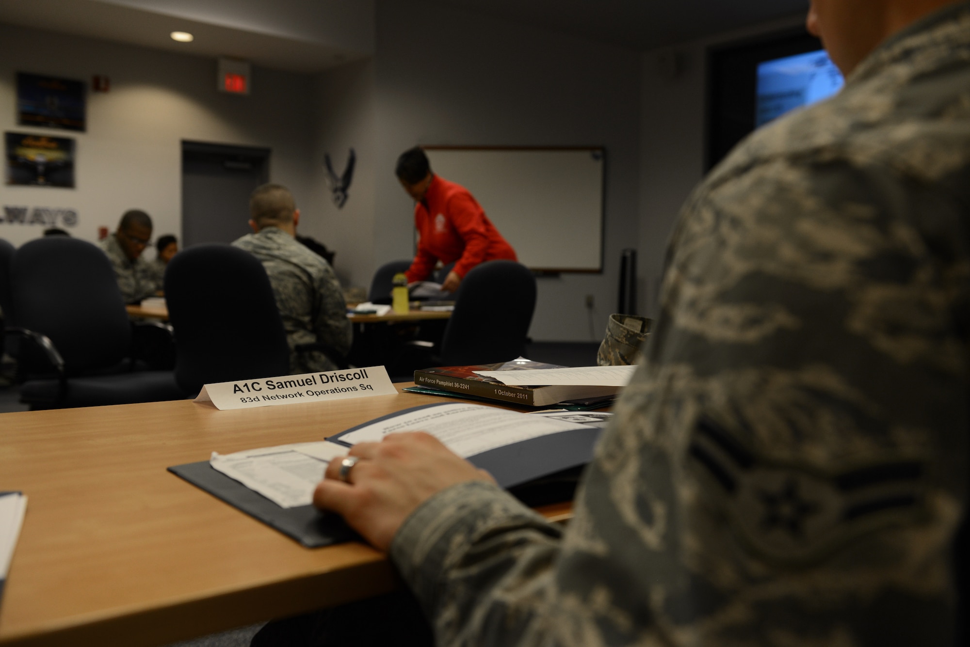 U.S. Air Force Airman 1st Class Samuel Driscoll, 83rd Network Operation Squadron network focal point technician, listens to Anna Bennett 633rd Force Support Squadron community readiness specialist, brief on personal financial management as part of the First Term Airmen Center at Langley Air Force Base, Va., Feb. 12, 2014. While in FTAC, the Airmen get the opportunity to meet the leadership of Langley, which includes a chief master sergeant mentorship lunch on Mondays and a briefing with Col. John J. Allen, 633rd Air Base Wing commander. Driscoll hails from Pittsburg, Pa. and Bennett from Dover, Del. (U.S. Air Force photo by Airman 1st Class Kimberly Nagle/Released) 