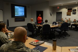 Anna Bennett, 633rd Force Support Squadron community readiness specialist, briefs a First Term Airmen Center class at Langley Air Force Base, Va., Feb. 12, 2014. The FTAC course teaches Airmen details of the installation, surrounding area and general Air Force knowledge. Bennett hails from Dover, Del. (U.S. Air Force photo by Airman 1st Class Kimberly Nagle/Released)