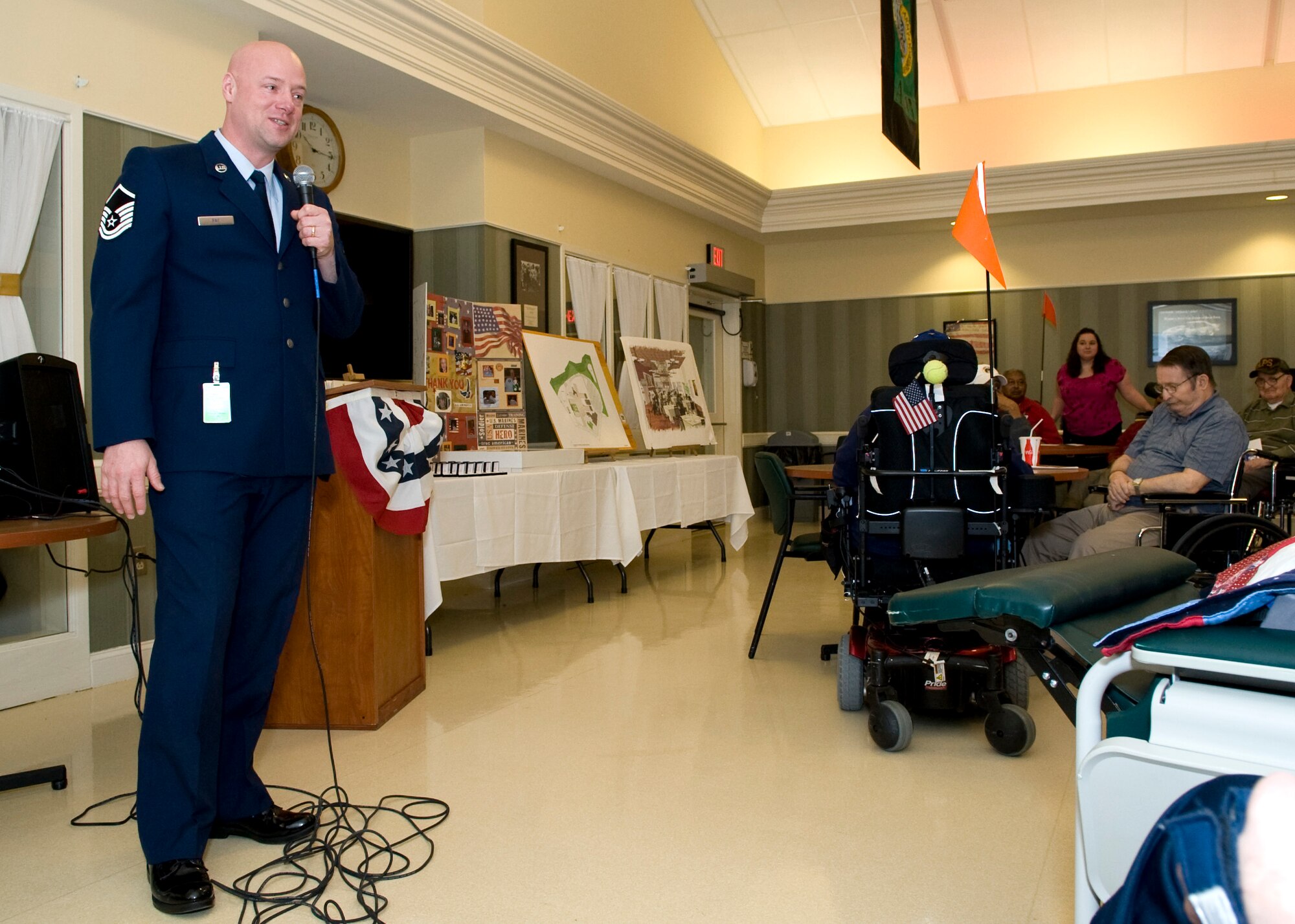 Master Sgt. Benjamin Fay, 9th Airlift Squadron loadmaster, talks to veterans during a five year recognition event Feb. 19, 2014, at the Delaware Veterans Home (DVH) in Milford, Del. Fay, a member of the Dover Air Force Base Top 3 organization, attended this event to present five year commemorative pins to those residents who have called the DVH their home for five-plus years. (U.S. Air Force photo/Airman 1st Class Zachary Cacicia) 