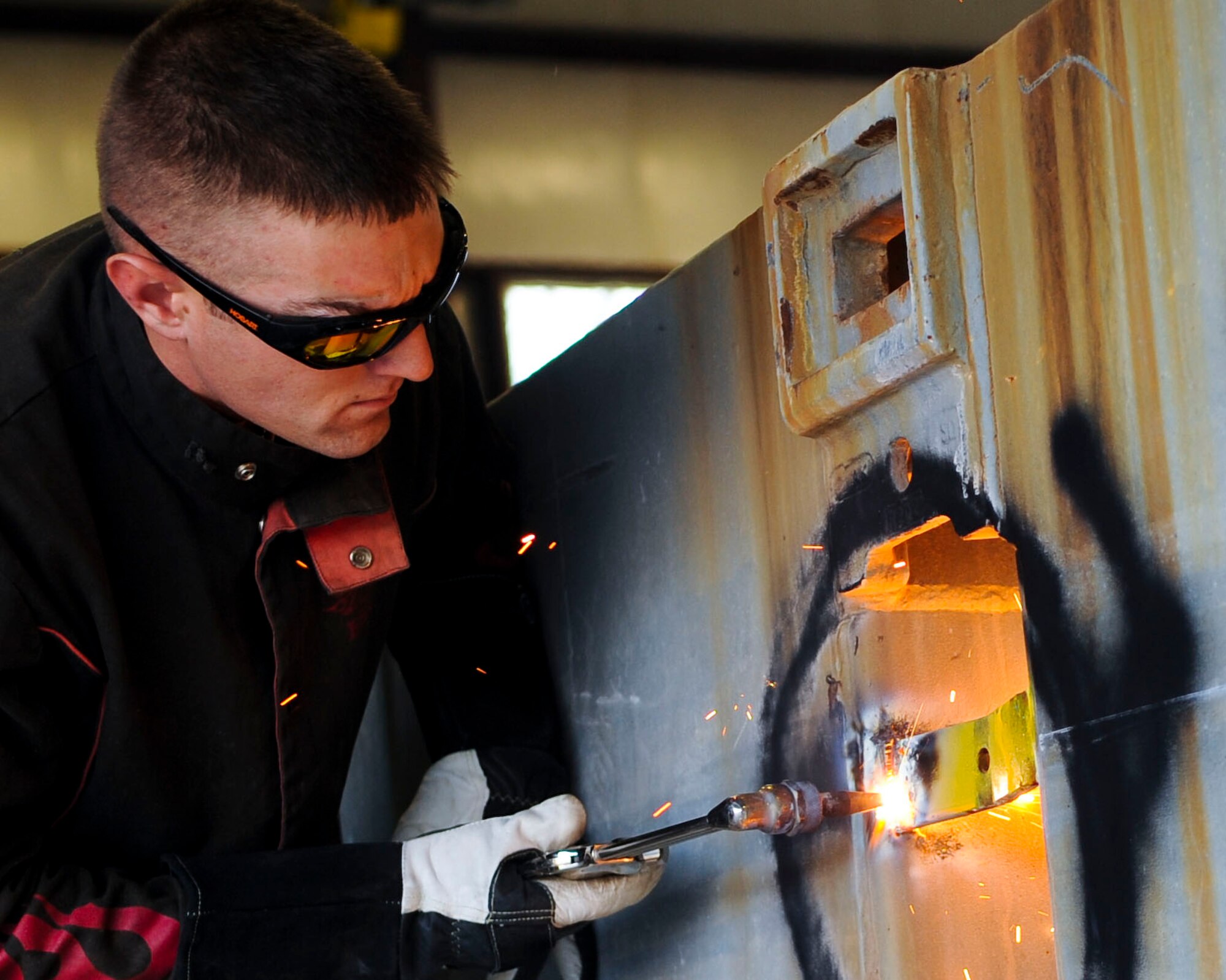 U.S. Army Spc. Andrew Phillips, 558th Transportation Company, Special Troops Battalion, 7th Transportation Brigade (Expeditionary) allied trade specialist, repairs a causeway at Fort Eustis, Va., Feb. 19, 2014. Soldiers repaired dents and other structural damage to 7th TB(X) causeways. (U.S. Air Force photo by Senior Airman Austin Harvill/Released)