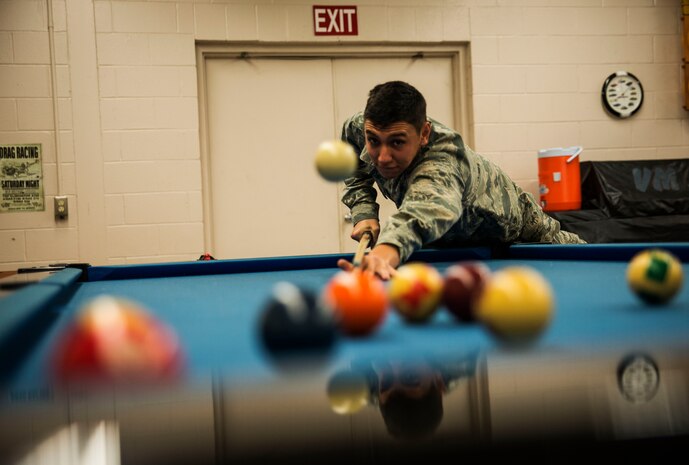Airman Basic Jose Segura, 628th Logistics Readiness Squadron vehicle maintainer apprentice, plays a game of pool during his 15-minute break after working on a deicer vehicle Feb. 11, 2014, at Joint Base Charleston, S.C. Vehicle maintainers take time to relax during their break times, because it can be stressful working on the various vehicles that come through the shop. (U.S. Air Force photo/ Senior Airman Dennis Sloan)