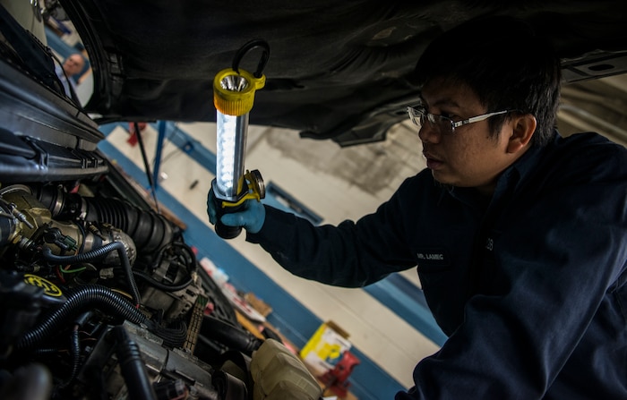 Elmo Lameg, 628th Logistics Readiness Squadron vehicle maintainer craftsman, uses a light to complete an inspection on an engine he rebuilt Feb. 11, 2014, at Joint Base Charleston, S.C. Vehicle maintenance technicians maintain JB Charleston's entire vehicle fleet, keeping cars, trucks and buses operating smoothly. (U.S. Air Force photo/ Senior Airman Dennis Sloan)