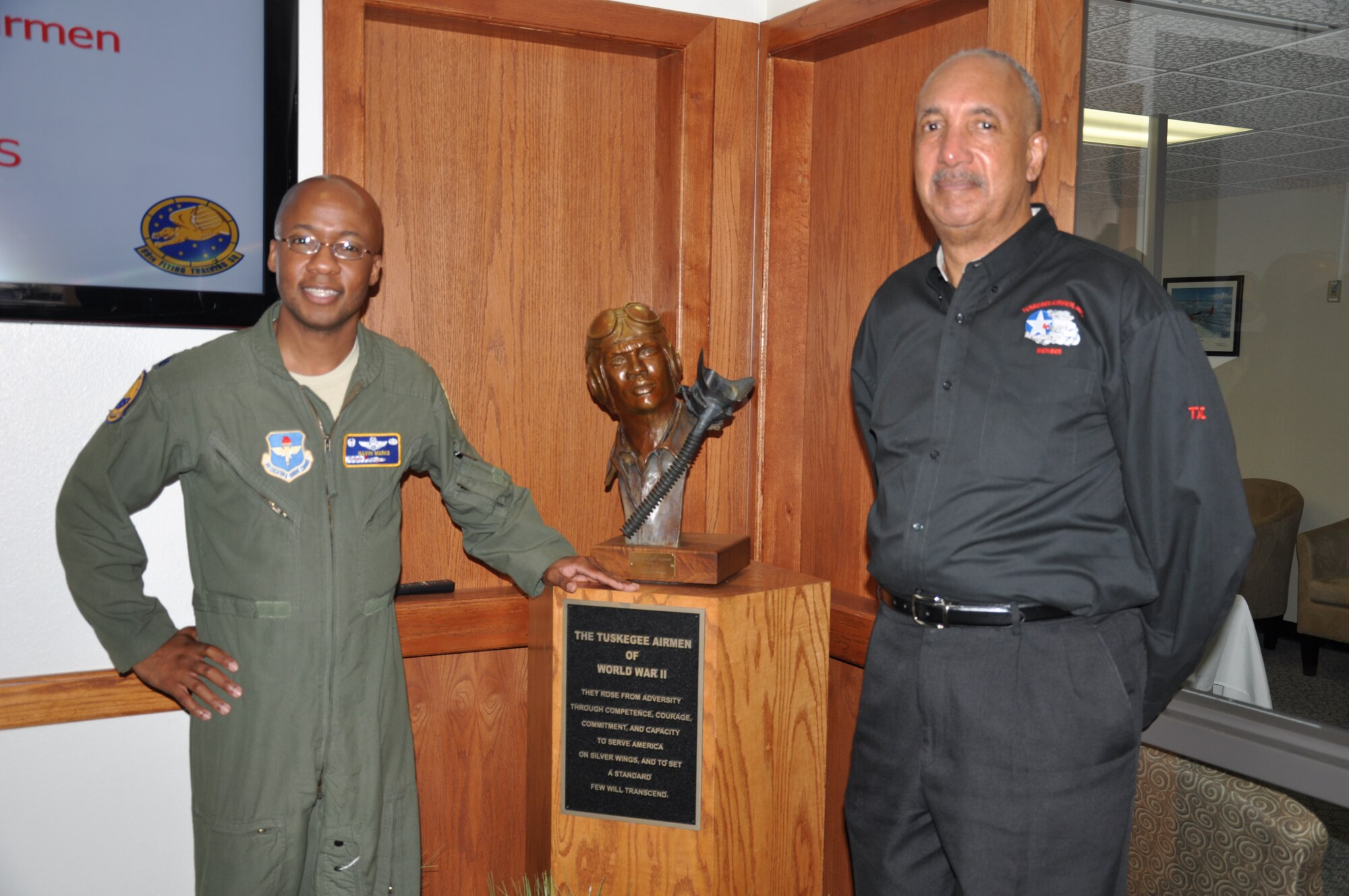 Lt. Col. Gavin Marks, 99th Flying Training Squadron commander, and Ralph
Sinkfield, President of the San Antonio Chapter, Tuskegee Airmen, Inc.,
stand by a Tuskegee Airman statue in the 99th FTS building at Joint Base San
Antonio-Randolph Feb. 19, 2014. The 99th FTS traces its historical lineage
to the 99th Pursuit Squadron, the first African American fighter squadron in
the Army Air Force and the first to deploy overseas. (U.S. Air Force photo
by Capt. Jennifer Richard)
