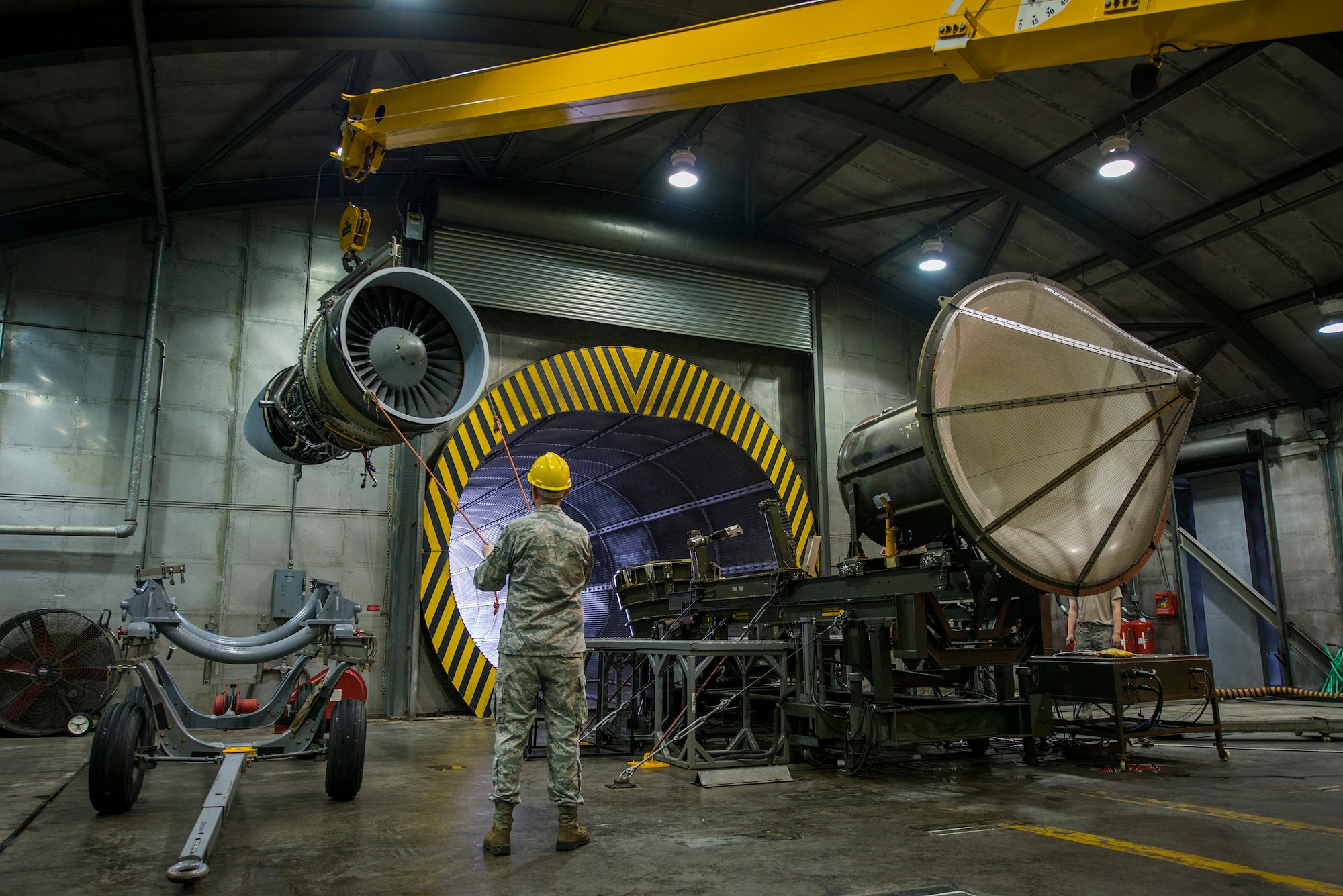 U.S. Air Force Senior Airman Brandon Barker, 23d Component Maintenance Squadron aerospace propulsion journeyman, guides an A-10C Thunderbolt II TF34 engine onto a stand at Moody Air Force Base, Ga., Feb. 21, 2014. Each TF34 engine can produce up to 9,275 pounds of thrust. (U.S. Air Force photo by Airman 1st Class Ryan Callaghan/Released)