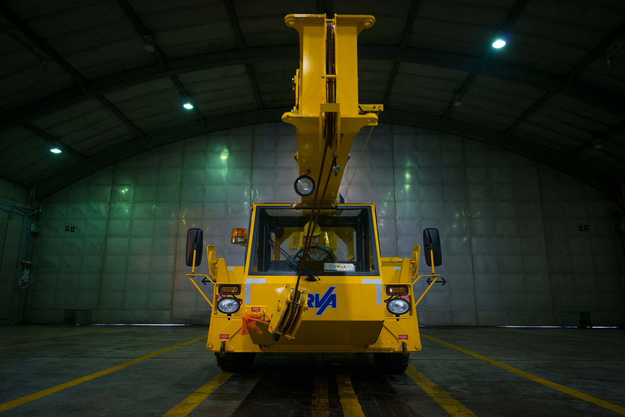 U.S. Air Force Staff Sgt. Michael Griggs, 23d Component Maintenance Squadron aerospace propulsion craftsman, prepares to operate a crane in the engine test cell facility at Moody Air Force Base, Ga., Feb. 21, 2014. After aircraft engine repairs are complete, the engine is brought to the test cell facility for functionality testing. (U.S. Air Force photo by Airman 1st Class Ryan Callaghan/Released)