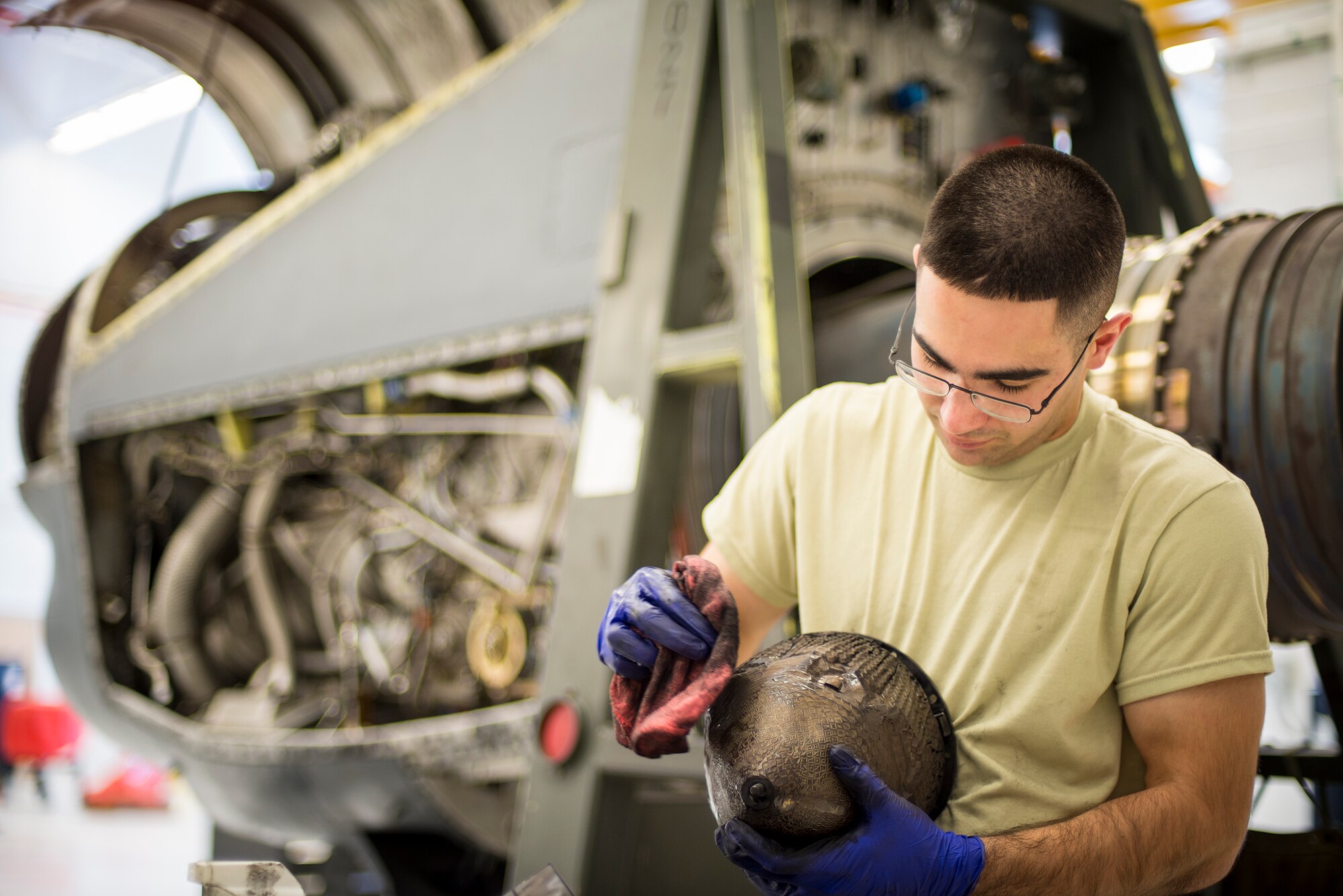 U.S. Air Force Airman 1st Class Vivek LeBouef, 723d Aircraft Maintenance Squadron aerospace propulsion apprentice, cleans parts as they are removed from a T56 engine at Moody Air Force Base, Ga., Feb. 19, 2014. The T56 is the turboprop engine installed on C-130 aircraft. (U.S. Air Force photo by Airman 1st Class Ryan Callaghan/Released)