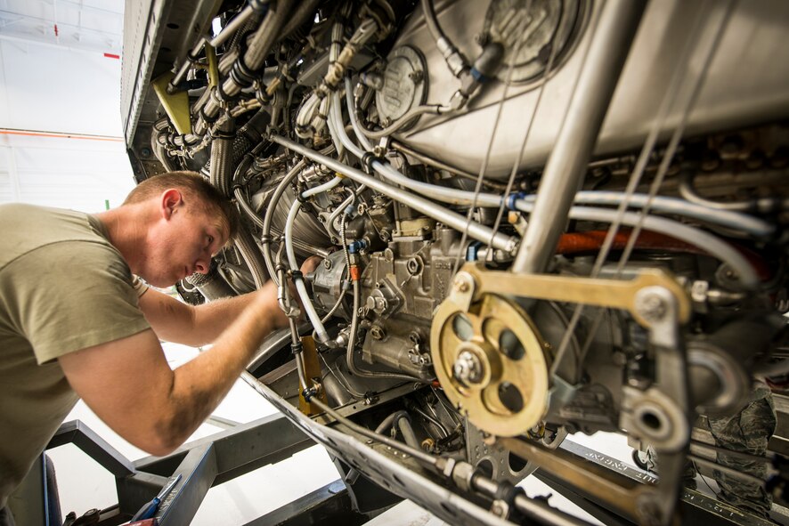 U.S. Air Force Airman 1st Class Jeffrey Wilson, 723d Aircraft Maintenance Squadron aerospace propulsion journeyman, loosens bolts in a T56 engine used on C-130 aircraft at Moody Air Force Base, Ga., Feb. 19, 2014. Aerospace propulsion Airmen diagnose engine problems, replace defective components and test run repaired engines. (U.S. Air Force photo by Airman 1st Class Ryan Callaghan/Released)