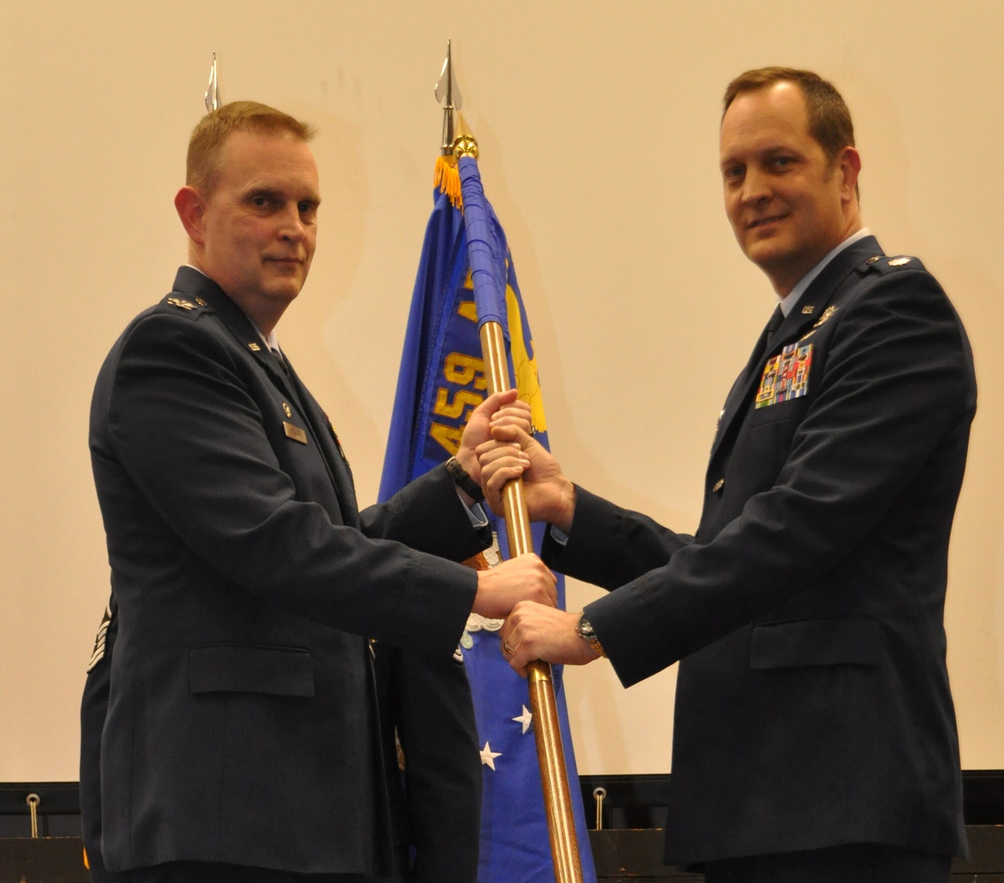 Air Force Lt. Col. Michael Moeding discusses his plans as new commander of the 459th Operations Group, during a change of command ceremony held in the 459th Air Refueling Wing auditorium, Feb. 22, 2014. Col. William Mason, 459 ARW commander, presided over the ceremony for Moeding and Col. Brian Davis, departing 459 OPS commander. (U.S. Air Force photo by/ Staff Sgt. Amber J. Russell)