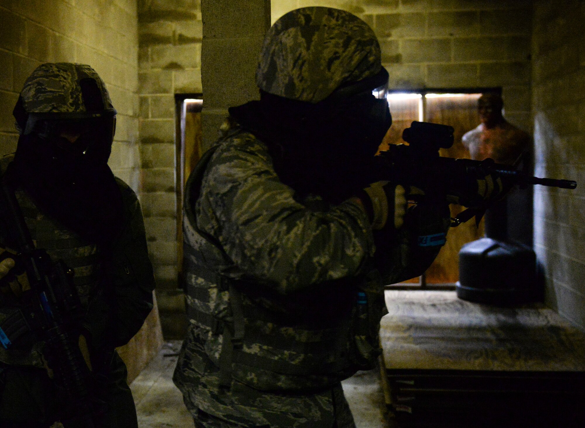 U.S. Air Force Col. Edward Ford, 23d Mission Support Group commander, clears a building at the military operations in urban terrain (MOUT) village at Moody Air Force Base, Ga., Feb. 21, 2014. After completing the classroom portion of the training, the 23d Wing leadership geared up and applied the skills they learned at MOUT village. (U.S. Air Force photo by Senior Airman Olivia Bumpers/Released)