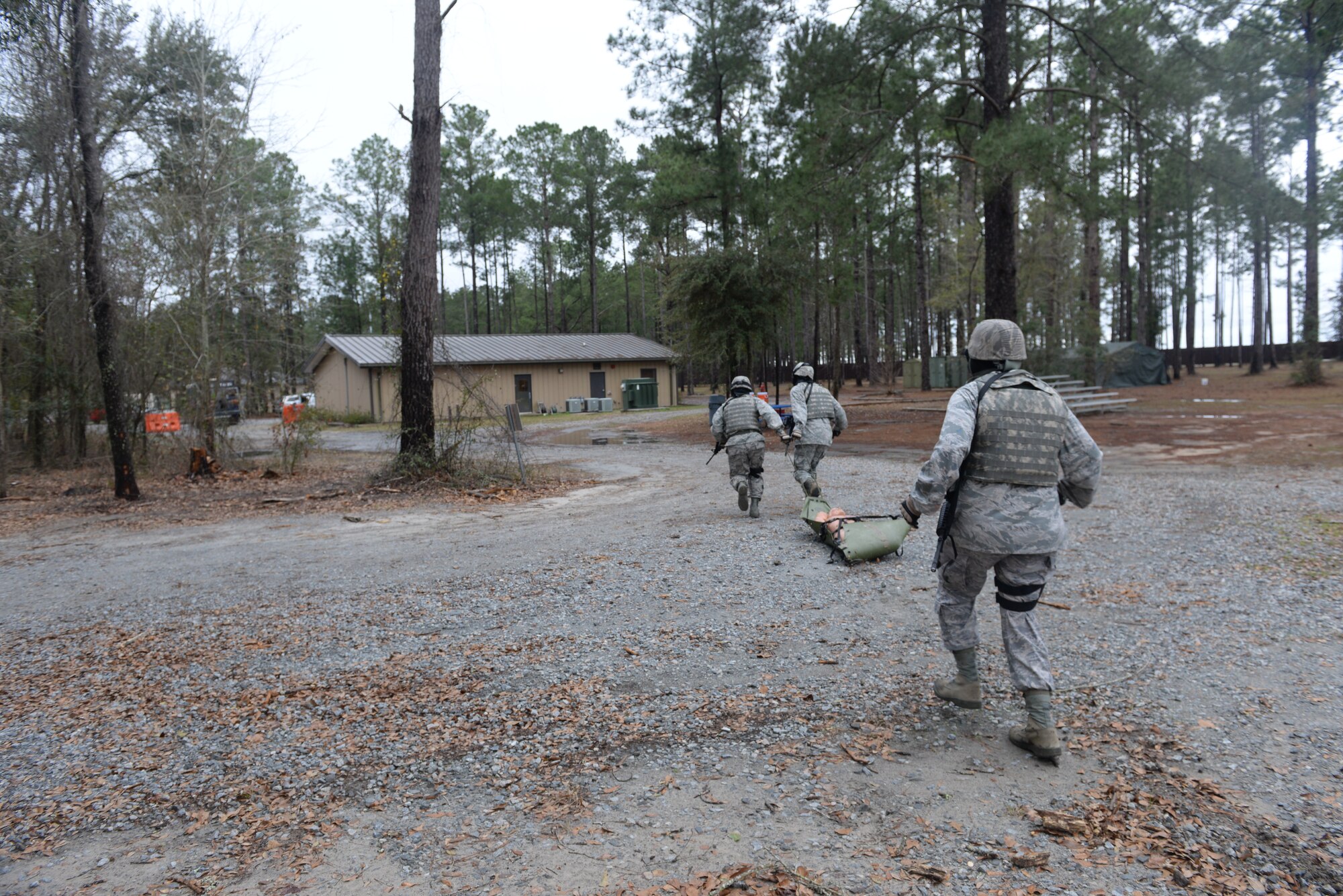23d Wing leadership drags a dummy back to safety at Moody Air Force Base, Ga., Feb. 21, 2014. Team A and B paired up to complete a rescue mission at the military operations in urban terrain village. (U.S. Air Force photo by Senior Airman Olivia Bumpers/Released)