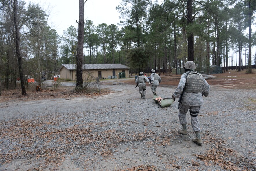 23d Wing leadership drags a dummy back to safety at Moody Air Force Base, Ga., Feb. 21, 2014. Team A and B paired up to complete a rescue mission at the military operations in urban terrain village. (U.S. Air Force photo by Senior Airman Olivia Bumpers/Released)