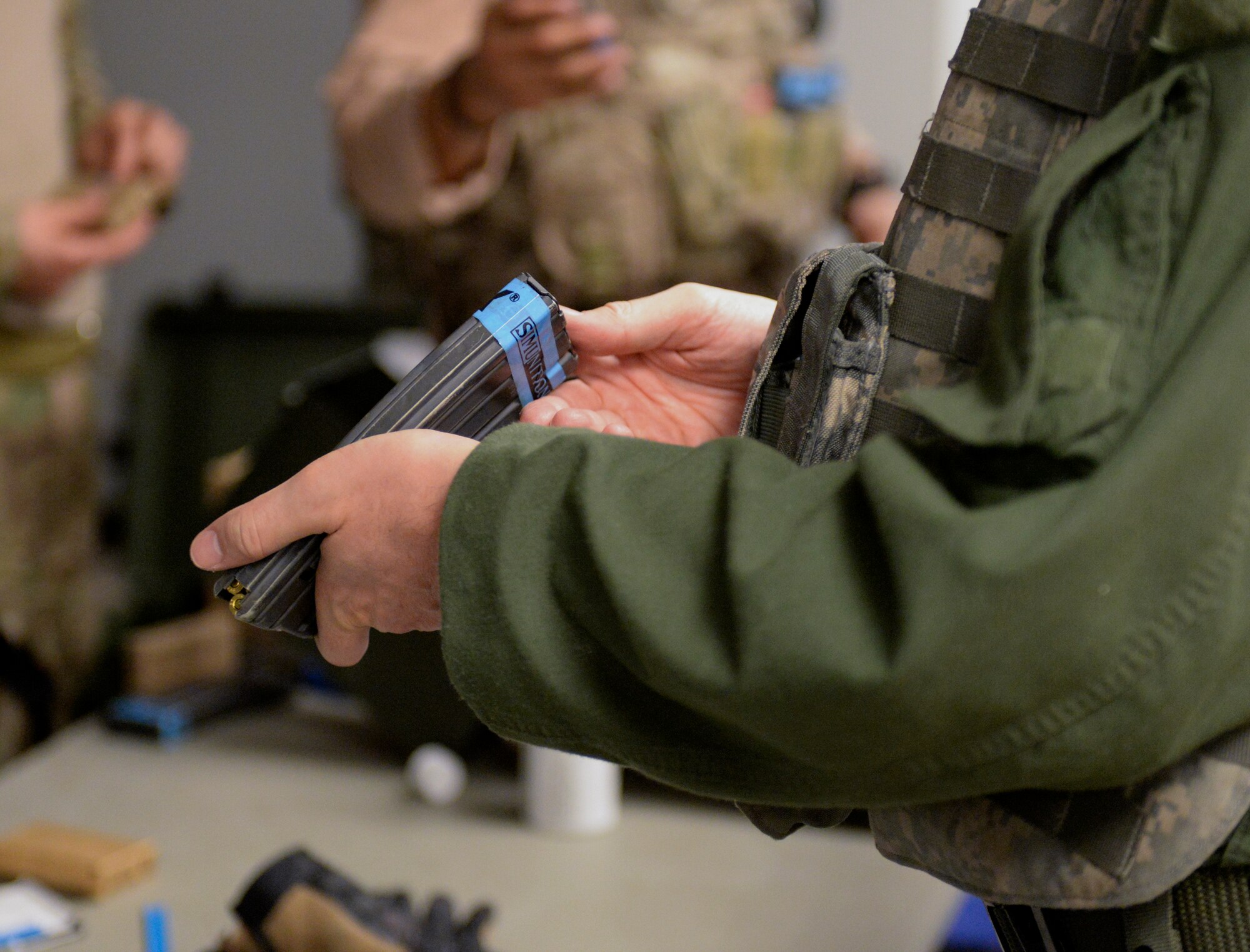 U.S. Air Force Col. Steven Gregg, 347th Rescue Group commander, reloads his clip at Moody Air Force Base, Ga., Feb. 21, 2014. Gregg along with the other commanders prepared for upcoming scenarios where they had to rescue a hostage while being attacked. (U.S. Air Force photo by Senior Airman Olivia Bumpers/Released)