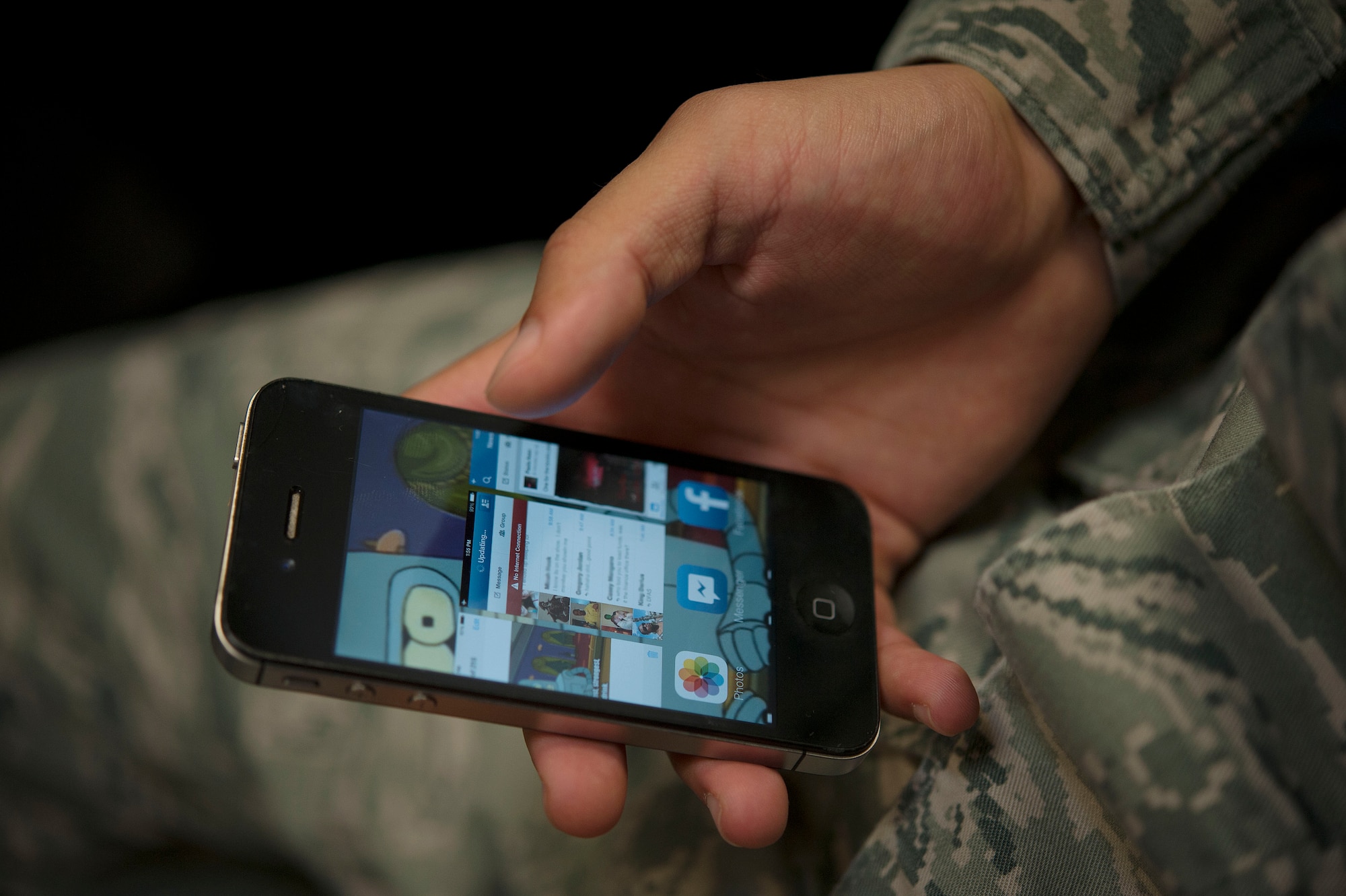 An Airmen scrolls through applications on a cellphone Jan. 31, 2014, at Incirlik Air Base, Turkey.  To have an operable foreign cellphone in Turkey you must register within 30 days of your arrival to Incirlik AB, bring your passport, NATO orders, military identification card and 115 Turkish Lira per phone.(U.S. Air Force photo by Senior Airman Nicole Sikorski/Released) 