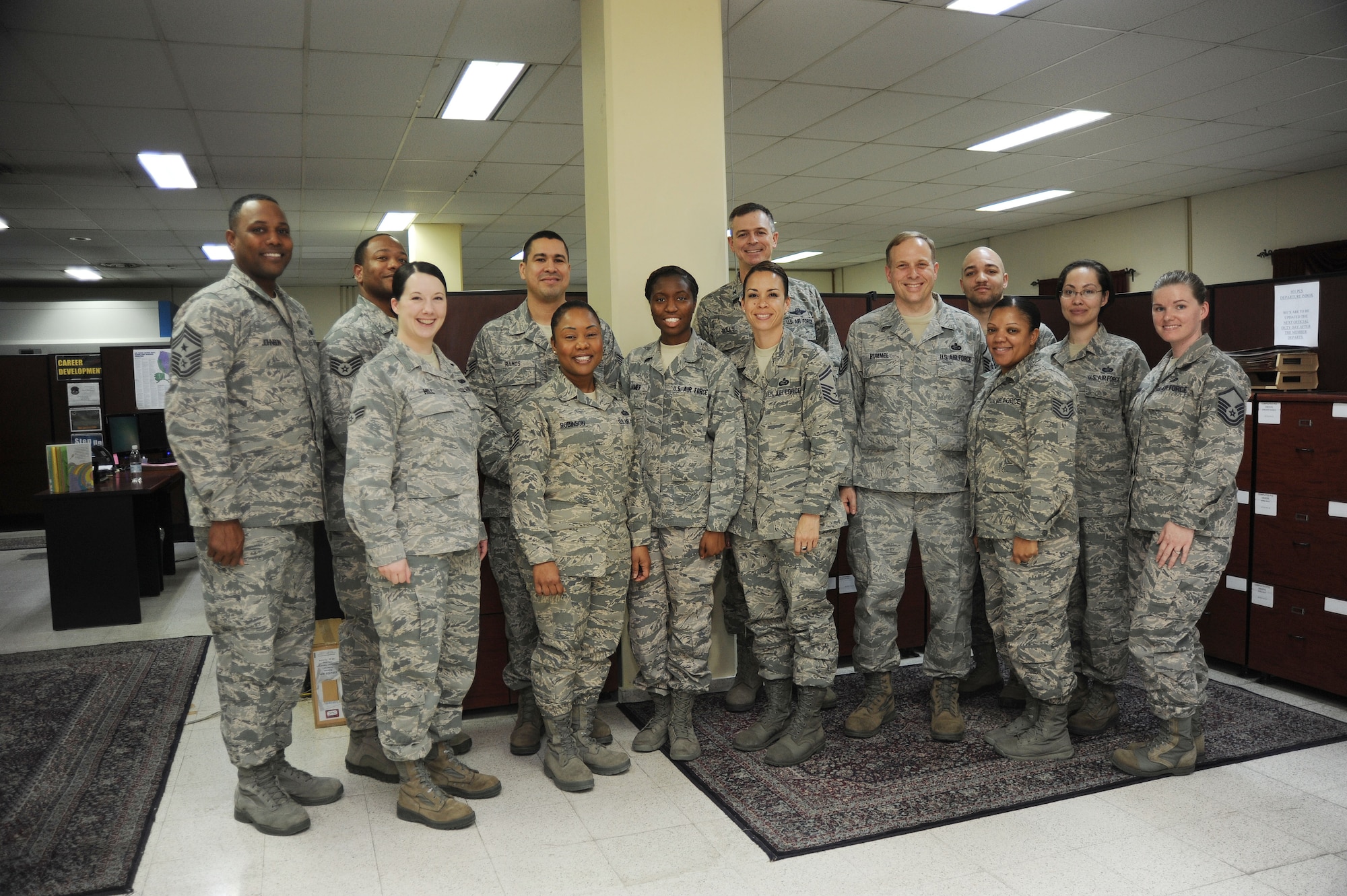 Airmen assigned to the 39th Force Support Squadron military personnel section pose for a group photo with Col. Craig Wills, 39th Air Base Wing commander, and Chief Master Sgt. Anthony Johnson, 39th ABW command chief, during their visit to the MPS Feb. 20, 2014, Incirlik Air Base, Turkey.  Wills and Johnson experienced the daily duties of MPS Airmen, and see how they provide quality personnel support to Air Force service members and their families.  (U.S. Air Force photo by Senior Airman Nicole Sikorski/Released)