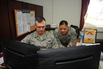 Tech. Sgt. Chanelle Wilburn, 39th Force Support Squadron NCO in charge of force management, reviews the enlisted performance report system with Col. Craig Wills, 39th Air Base Wing commander, Feb. 20, 2014, Incirlik Air Base, Turkey. The MPS is the strategic manager of military personnel programs for all 39th ABW members being serviced on or off base. (U.S. Air Force photo by Senior Airman Nicole Sikorski/Released) 