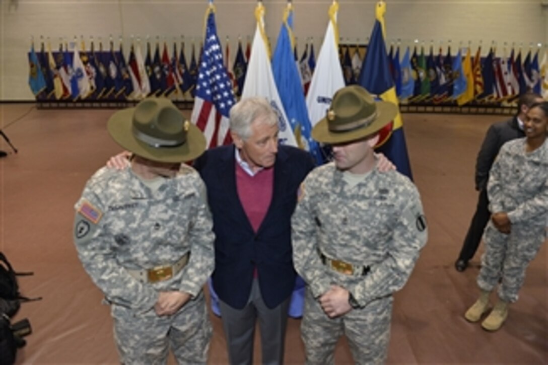Defense Secretary Chuck Hagel chats with two Army drill sergeants during his visit to Fort Eustis, Va., Feb. 25, 2014. Hagel, who also visited nearby Langley Air Force Base, is on a three-day trip during which he will participate in NATO meetings for defense ministers in Brussels.