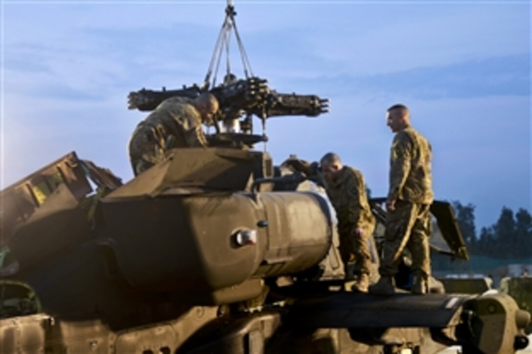 U.S. soldiers install a transmission in an AH-64 Apache helicopter on Forward Operating Base Fenty, Afghanistan, Feb. 14, 2014. The soldiers, who are maintainers, are assigned to 159th Combat Aviation Brigade.