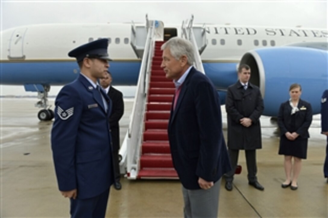 Defense Secretary Chuck Hagel talks with a member of the aircrew before departing Joint Base Andrews en route to visit troops on Joint Base Langley-Eustis, Va., Feb. 25, 2014. Hagel is on a three-day trip during which he also will participate in NATO defense minister meetings in Brussels.
