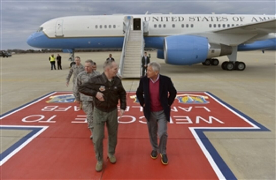 Defense Secretary Chuck Hagel walks with Air Force Gen. Mike Hostage, commander of the Air Combat Command, as he arrives on Langley Air Force Base in Hampton, Va., Feb. 25, 2014, to visit with troops. Hagel, who also visited nearby Fort Eustis, is on a three-day trip during which he will participate in NATO meetings for defense ministers in Brussels.