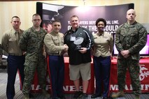 The head football and softball coach at Maple Lake High School, Coach Tim Knudsen, shakes hands with Commanding Officer of Marine Corps Recruiting Station Twin Cities, Maj. Christopher Tsirlis, after having received the Marine Corps Semper Fi Coach Award, Feb. 21.