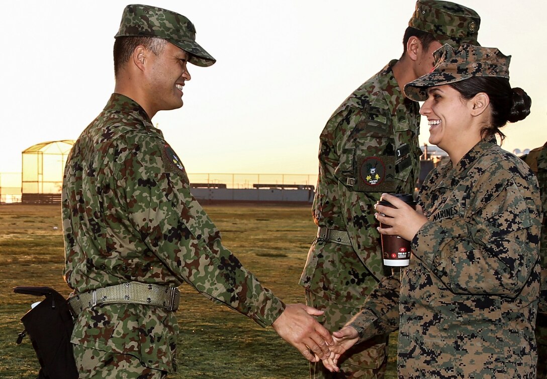 U.S. Marine Cpl. Abigail V. Reynolds, right, an interpreter assigned to the 15th Marine Expeditionary Unit, greets a Japanese interpreter with the Japan Ground Self-Defense Force, at helocast training during Exercise Iron Fist 2014 aboard Naval Amphibious Base Coronado, Calif., Jan. 27, 2014. Reynolds is a landing support specialist with Combat Logistics Regiment 27, 2nd Marine Logistics Group, aboard Marine Corps Base Camp Lejeune, N.C. (U.S. Marine Corps photo by Cpl. Emmanuel Ramos/Released)