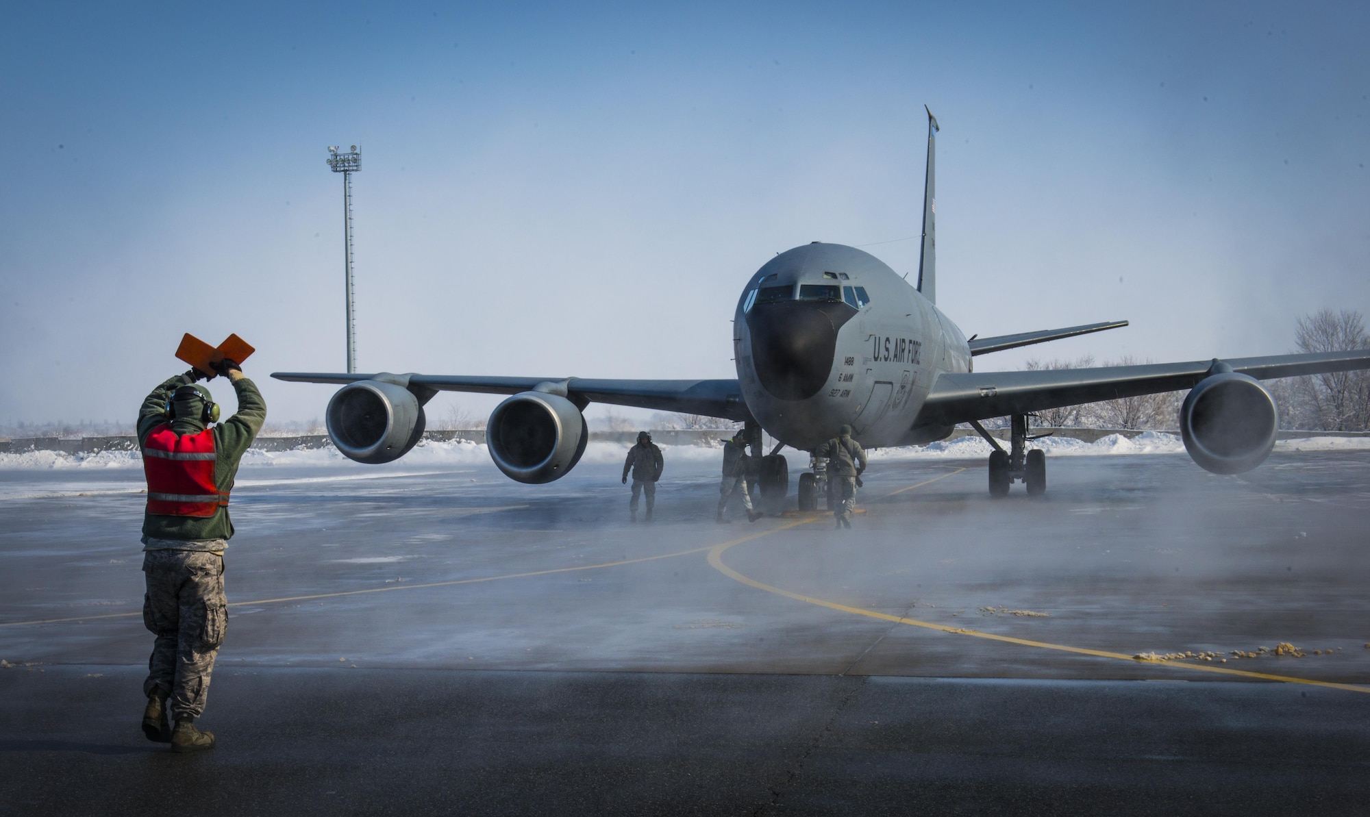 A crew chief with the 376th Expeditionary Aircraft Maintenance Squadron marshals in a KC-135 Stratotanker Feb. 24, 2014, after a flight at Transit Center at Manas, Kyrgyzstan. The flight was the last combat-refueling mission over Afghanistan from the Transit Center. (U.S. Air Force photo/Staff Sgt. Travis Edwards) 