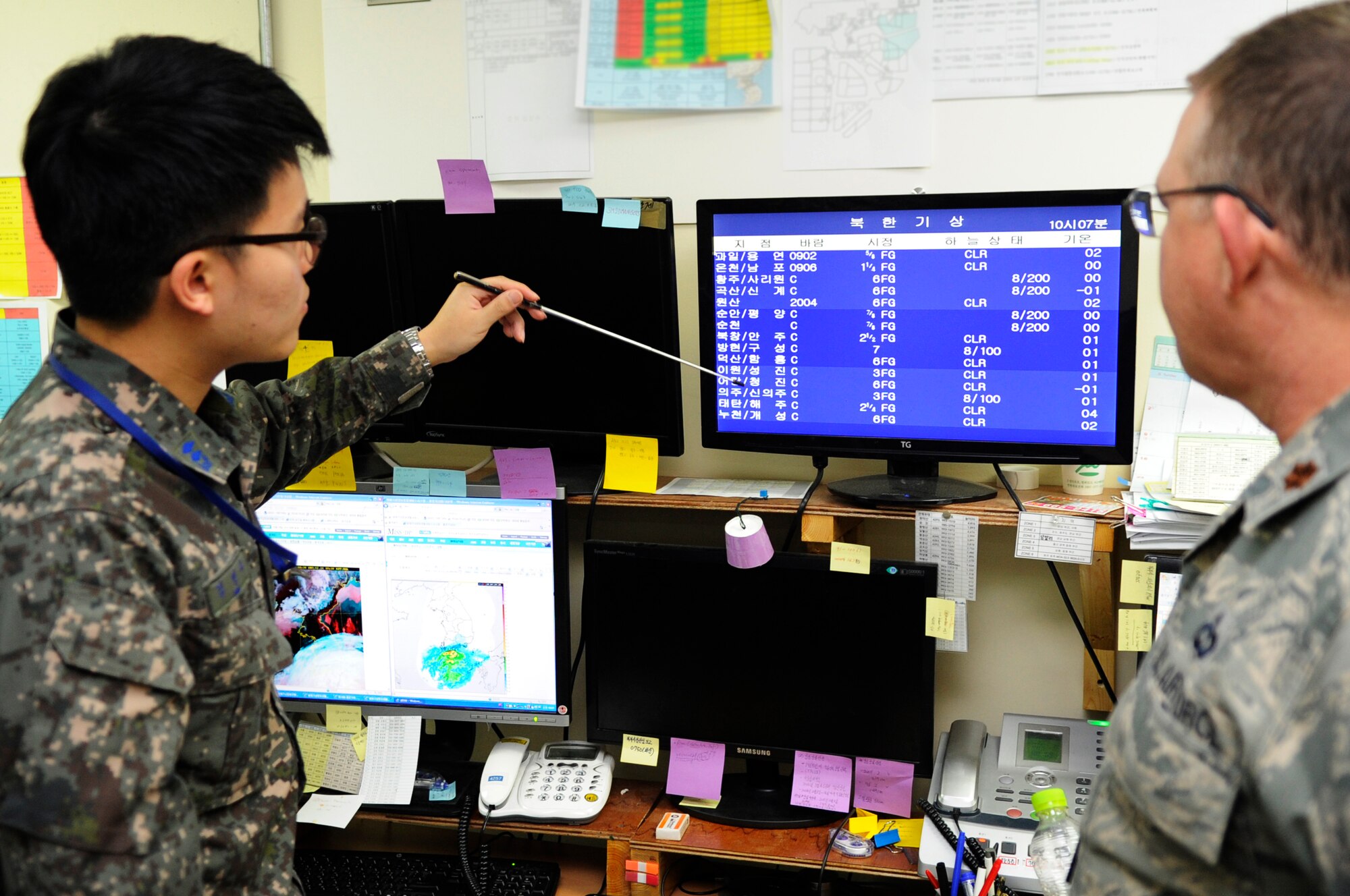 Republic of Korea Air Force 1st Lt. Seong Soo Kim, Osan Weather Squadron, briefs U.S. Air Force Maj. Gary Clinton, 607th Air Operations Center Combat Operations Division Weather Specialty team, chief of weather operations, during Exercise Key Resolve 2014 at Osan Air Base, Republic of Korea, Feb. 26, 2014. During exercises or wartime operations, the 607 AOC CODW, provides leaders weather information to help them exploit the weather for air, ground and naval assets and allow them to change battle tactics rapidly. (U.S. Air Force photo/Senior Airman Marcus Morris)