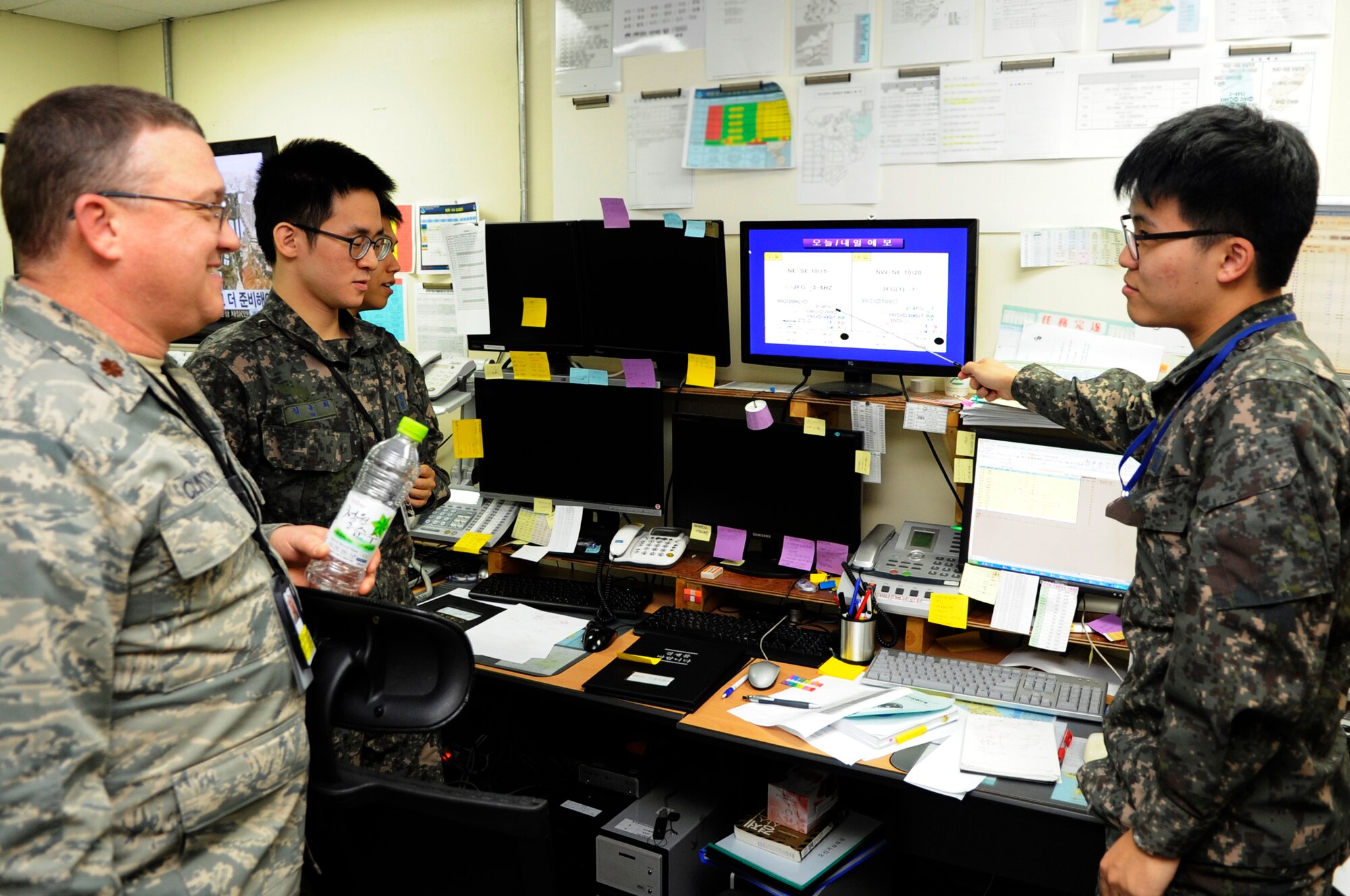 Republic of Korea Air Force 1st Lt. Seong Soo Kim, Osan Weather Squadron, briefs U.S. Air Force Maj. Gary Clinton 607th Air Operations Center Combat Operations Division Weather Specialty team chief of weather operations, during Exercise Key Resolve 2014 at Osan Air Base, Republic of Korea, Feb. 26, 2014. Weather information must be provided quickly and accurately to allow bombs to be dropped on target and forces properly placed. (U.S. Air Force photo/Senior Airman Marcus Morris)