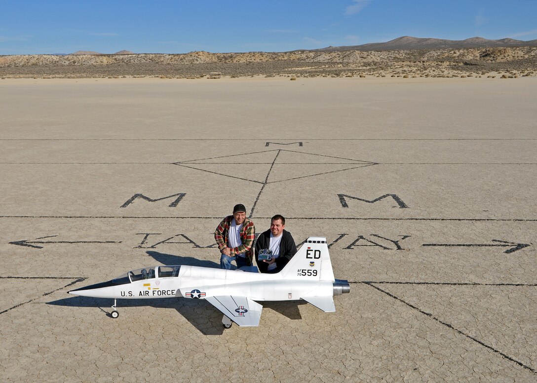 Rodger (left) and Brent Hecht pose with their 12-foot long T-38 Talon radio-controlled scale model on the Rosamond Dry Lakebed at the designated Muroc Model Masters flying field on Feb. 22, 2014. Rodger and Brent started flying R/C models with the Muroc Model Masters R/C Club nearly 20 years ago and decided to build their T-38 with an 82-inch wingspan. The fully-functional model weighs approximately 45 pounds, has two 5-inch electric ducted fans powered by brushless motors and the airframe is made of blue foam, carbon fiber, fiber glass, balsa wood and plywood. (U.S. Air Force photo by Jet Fabara)