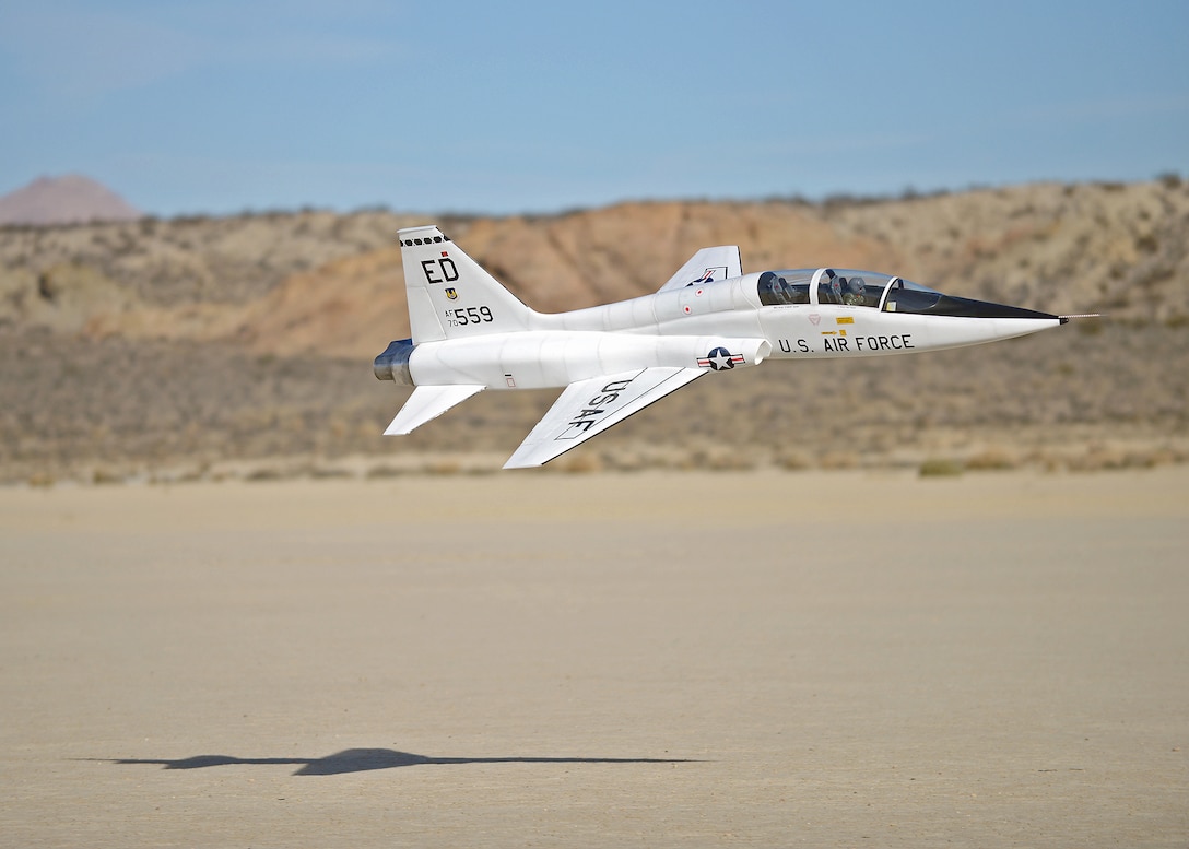 Brent Hecht performs a high-speed, low-level fly-by the Rosamond Dry Lakebed Feb. 22 with the 12-foot long T-38 Talon R/C replica he and his dad built. Rodger and Brent started flying R/C models with the Muroc Model Masters R/C Club nearly 20 years ago and decided to build their T-38 with an 82-inch wingspan. The fully-functional model weighs approximately 45 pounds, has two 5-inch electric ducted fans powered by brushless motors and the airframe is made of blue foam, carbon fiber, fiber glass, balsa wood and plywood. (U.S. Air Force photo by Jet Fabara)