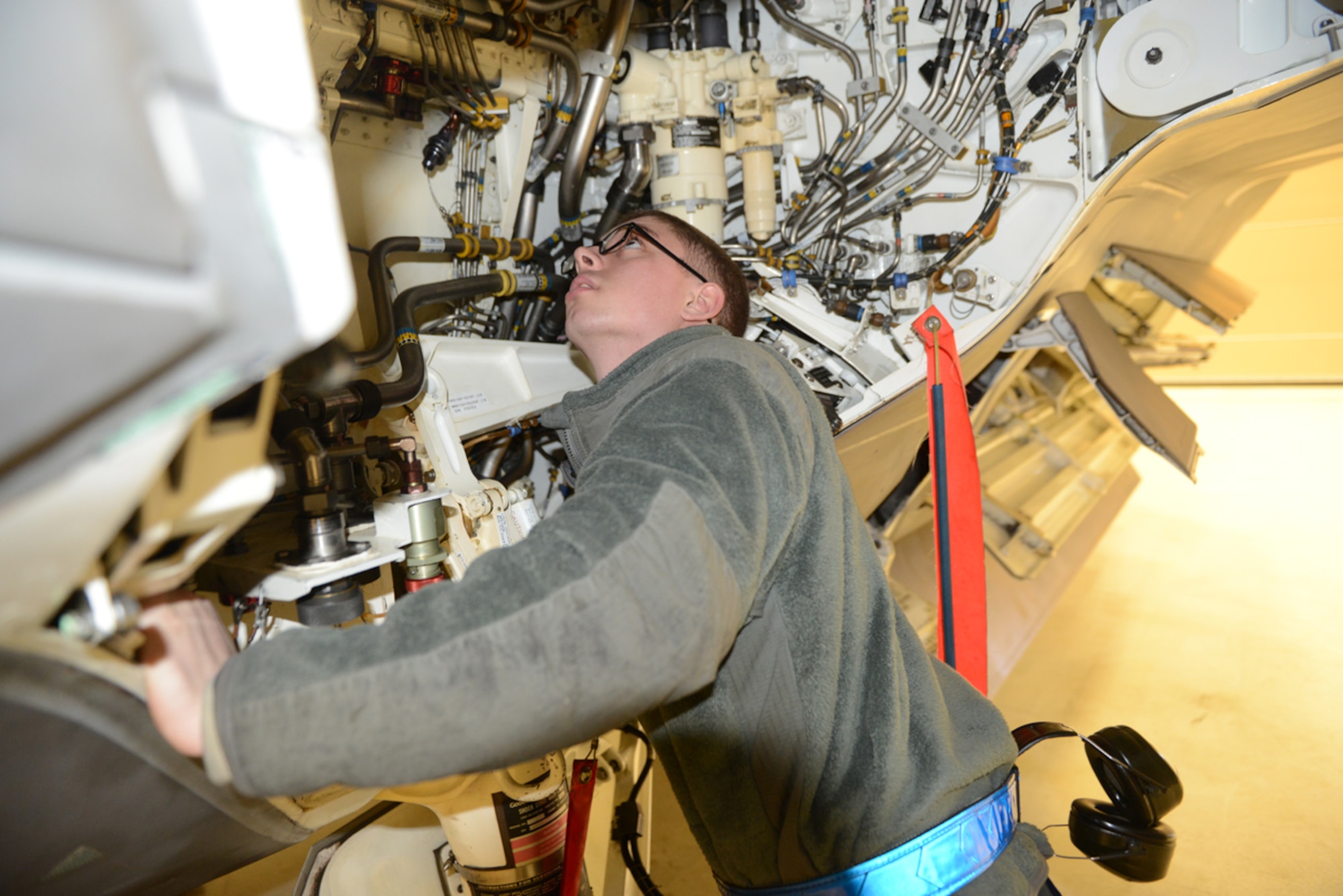 Airman 1st Class Michael Underwood, 525th Aircraft Maintenance Unit assistant dedicated crew chief, performs a hydraulic check on an F-22 Raptor at the 525th Fighter Squadron Feb. 21. Underwood earned the Pacific Air Force Aviation Safety Well Done Award for extinguishing a fire on board a Raptor that had just landed at Joint Base Elmendorf-Richardson Feb. 4. (U.S. Air Force photo/Airman 1st Class Ty-Rico Lea)