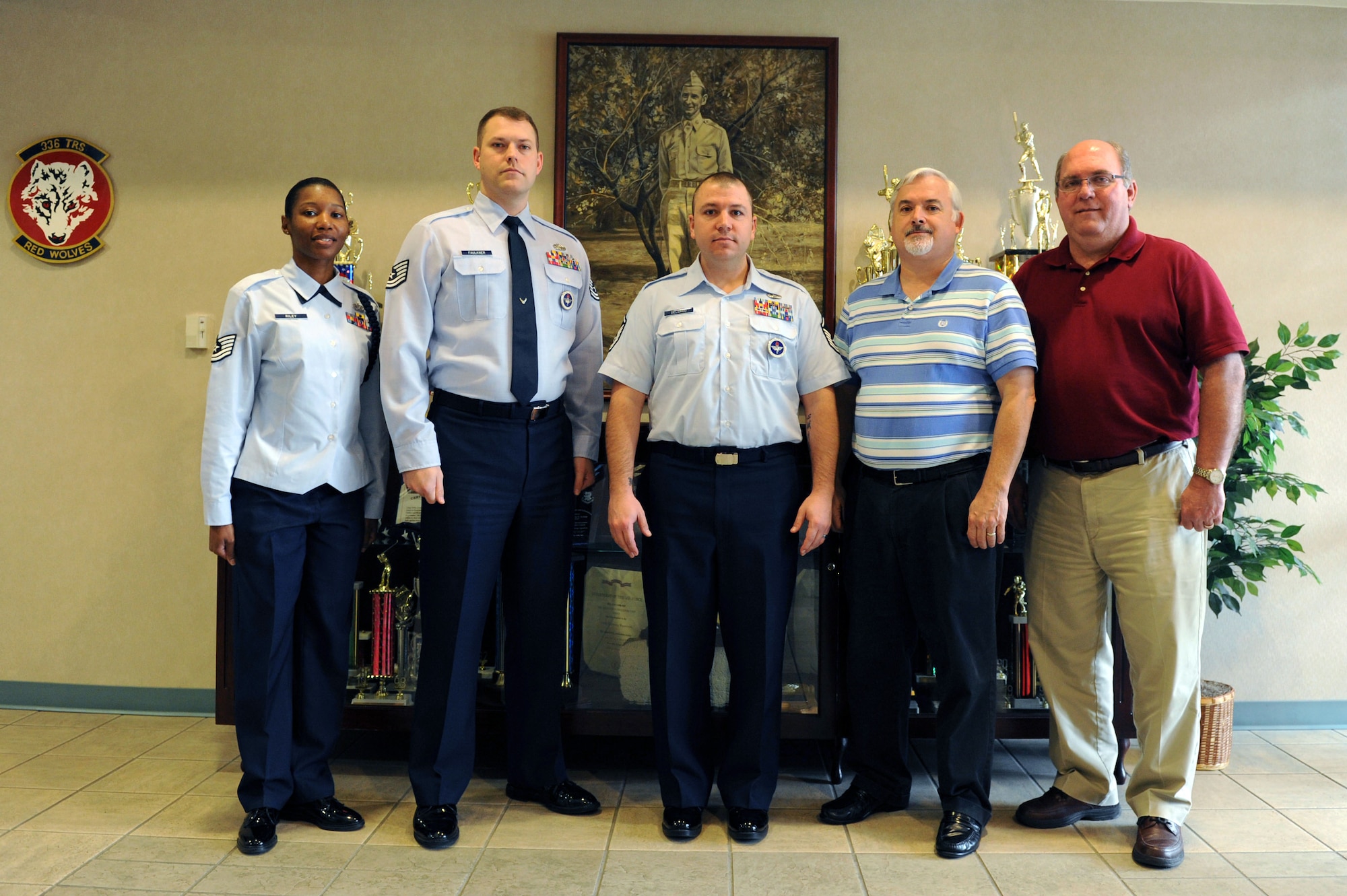 Tech. Sgt. Shaquanna Riley, Tech. Sgt. Joshua Faulkner, Master Sgt. James Delgado, Jesse Cheeseman and Gregory O’Neal, representatives of the 336th Training Squadron, stand in front of the trophy display, at Thomson Hall Feb. 24, 2014, Keesler Air Force Base, Miss. The 336th TRS was selected as the 81st Training Wing’s top technical training squadron for 2013. (U.S. Air Force photo by Airman 1st Class Stephan Coleman)