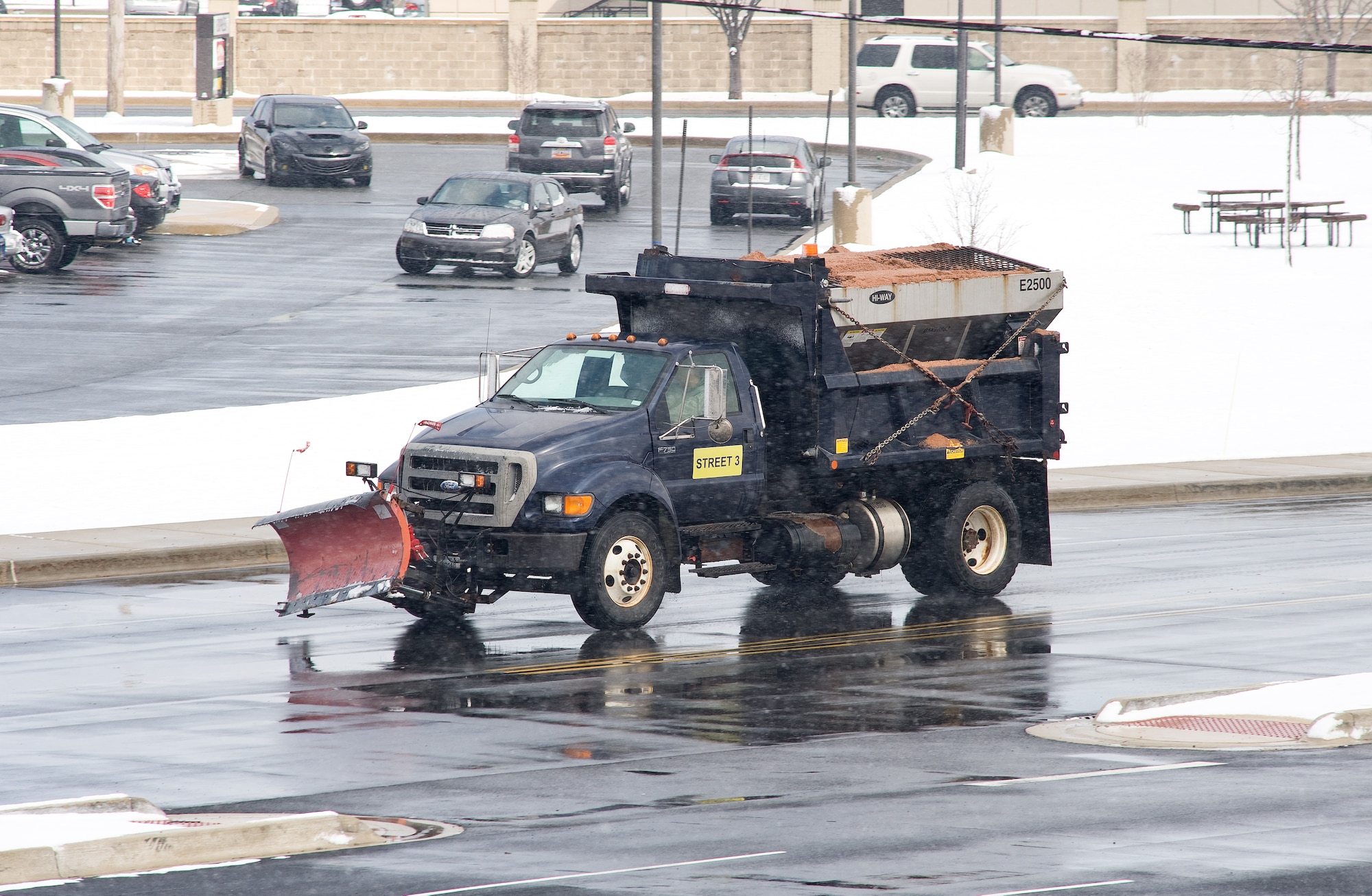 A snow removal vehicle from the 436th Civil Engineer Squadron patrols the streets Feb. 26, 2014, at Dover Air Force Base, Del. As the snow fell and even after, the base continued normal operations as Team Dover personnel initiated snow removal throughout the base, including the flight line, taxiways and runways. (U.S. Air Force photo/Roland Balik)