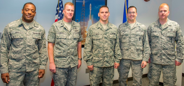 (Left to Right) Chief Master Sgt. Jeffrey Hall, 45th Launch Group; Col. Matthew Skeen, 45th LCG commander; Tech. Sgt. Benjamin Smith, 45th SW Launch Support Squadron; Lt. Col. Paul Konyha III, 45th SW LCSS commander; and Senior Master Sgt. Christopher Moore, 45th LCSS pose for a photo at Cape Canaveral Air Force Station, Fla., Feb. 21, 2014, after congratulating Smith for him for earning an extra stripe under the Air Force’s Stripe for Exceptional Performers program. The STEP program allows Air Force leaders to select Airmen with outstanding potential for promotion to the grades of staff sergeant through master sergeant. (U.S. Air Force photo/Matthew Jurgens)