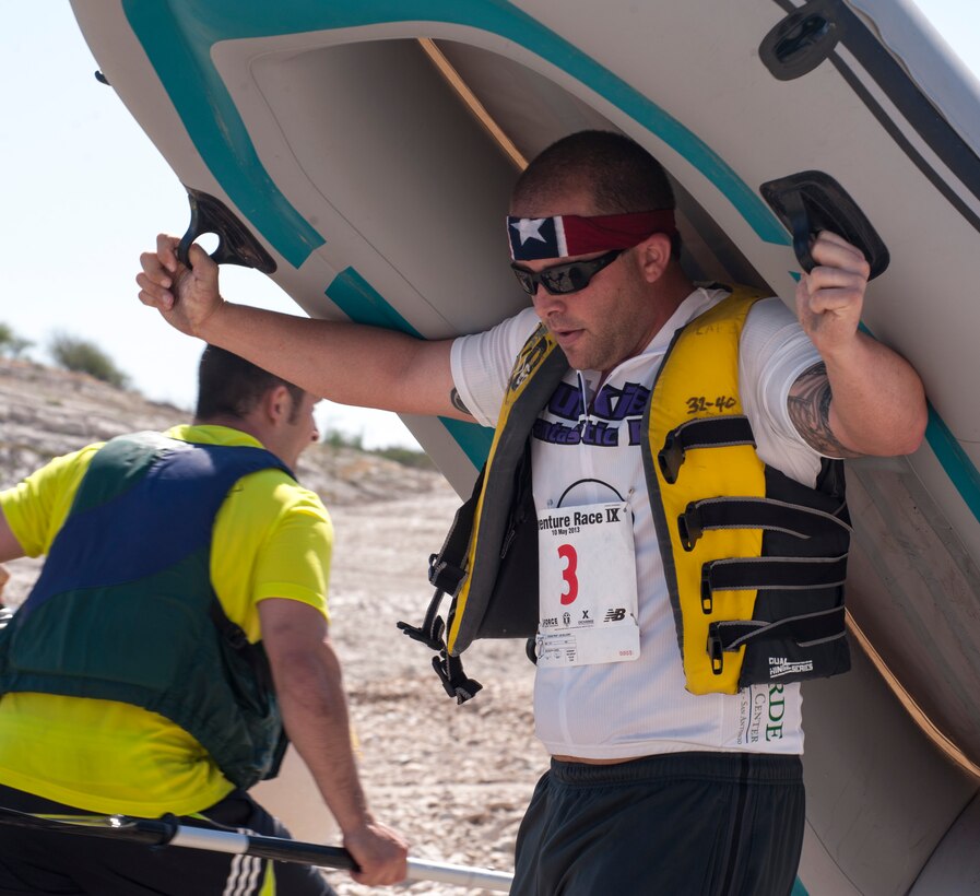 A competitor at the ninth annual Adventure Race carries raft to the water at the Laughlin Marina near Del Rio, Texas, May 11, 2013. Adventure Race IX introduced the chance for individual competitors to compete in the event. More than 5,000 people have competed in the race across Val Verde County. This year the race will be held on May 3.(U.S. Air Force photo/Senior Airman Nathan Maysonet)