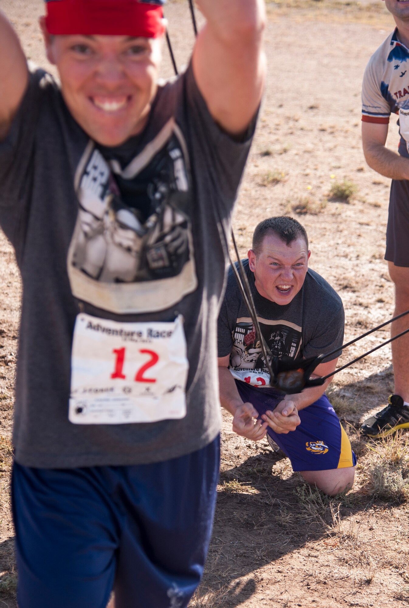 A team readies a water balloon, to fire at a target for a special event, during Adventure Race IX at Laughlin Air Force Base, Texas, May 11, 2013. Adventure Race has special mystery events during the competition for added fun that are not announced until the day of the race. More than 5,000 people have competed in the race across Val Verde County. This year the race will be held on May 3. (U.S. Air Force photo/Senior Airman Nathan Maysonet)