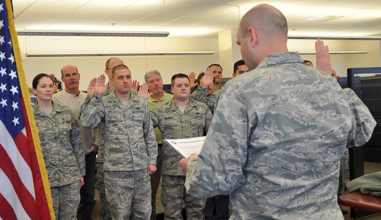 Maj. Nick Sanders, installation inspector general, swears in new members of the wing inspection team here Feb. 19. The wing inspection team is made up of members who have been identified as subject matter experts in some field. These members also undergo inspection team training and will be utilized to carry out wing inspections sponsored by the IG. (U.S. Air Force photo/Scott Prater)