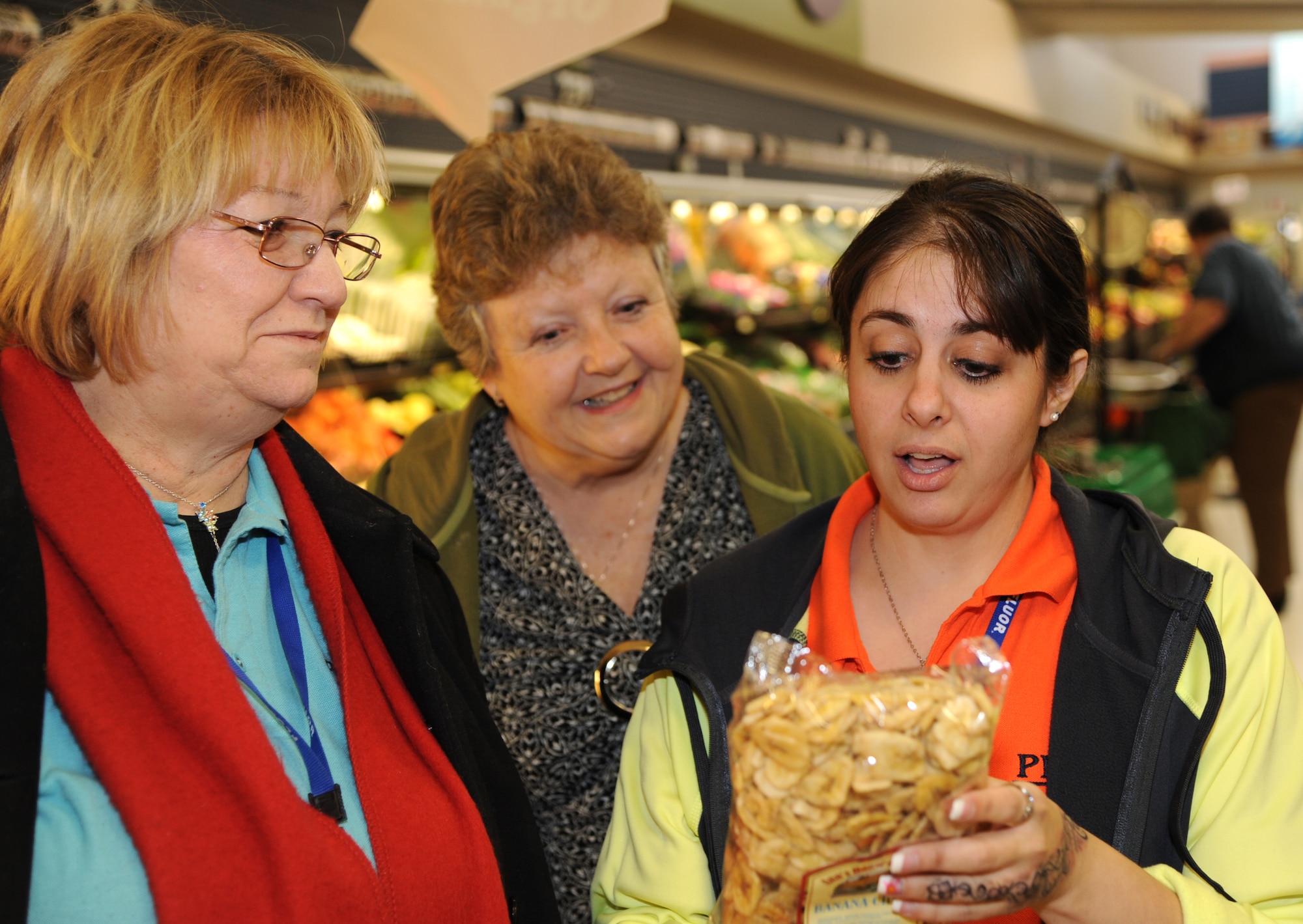 From left, Charlotte Martin, Roxanne Johnson and Jennifer Todd, PAE employees at Vance Air Force Base, read the nutrition label on a bag of dehydrated banana slices during the shopping portion of the Health and Wellness Center’s class, “Planning, Shopping, and Cooking for Health.” (U.S. Air Force photo/ Senior Airman Frank Casciotta)