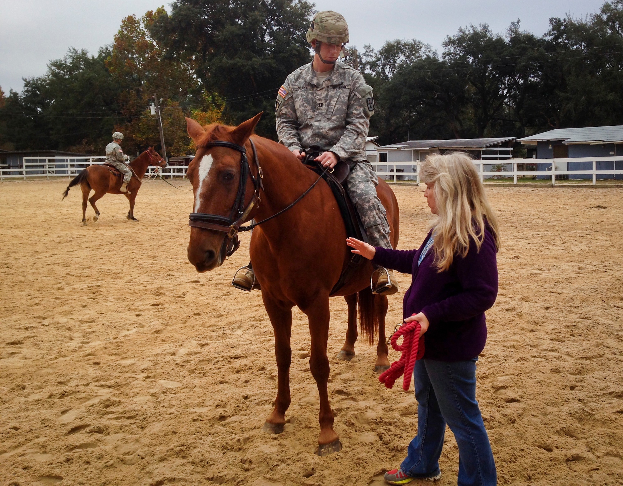 A Sand and Spur Riding Club volunteer helps a Soldier get comfortable on horseback during a training session in late 2013 at Eglin Air Force Base, Fla.  Eglin’s riding club providing training on how to saddle, pack and ride horses to EOD Army officers as proactive exercise in case they were ever required to do so during a deployment.  (Courtesy photo)