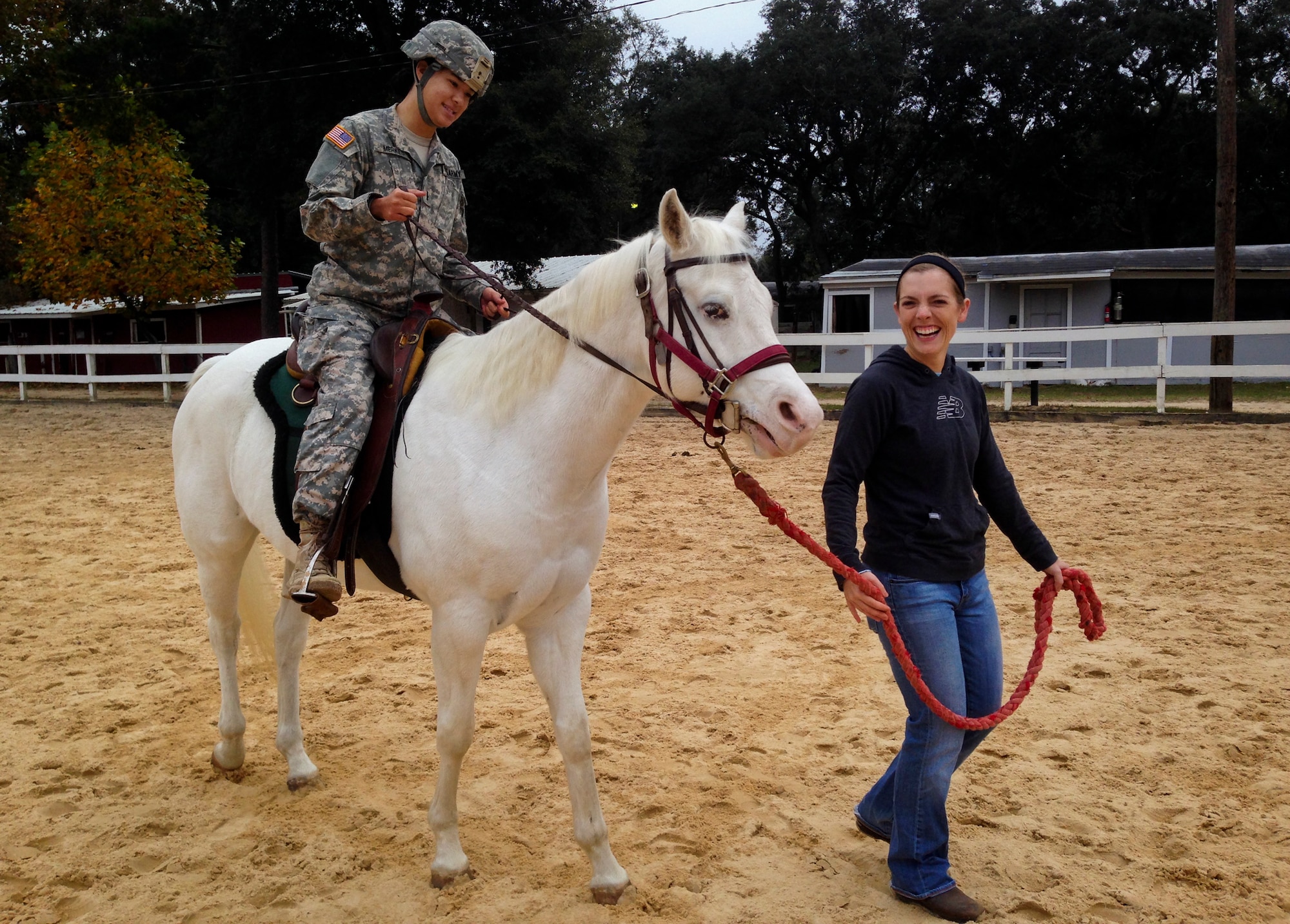 Michelle Lukenbill helps a Soldier get comfortable on horseback during a training session in late 2013 at Eglin Air Force Base, Fla.  Eglin’s Sand and Spur Riding Club providing training on how to saddle, pack and ride horses to EOD Army officers as proactive exercise in case they were ever required to do so during a deployment.  (Courtesy photo)