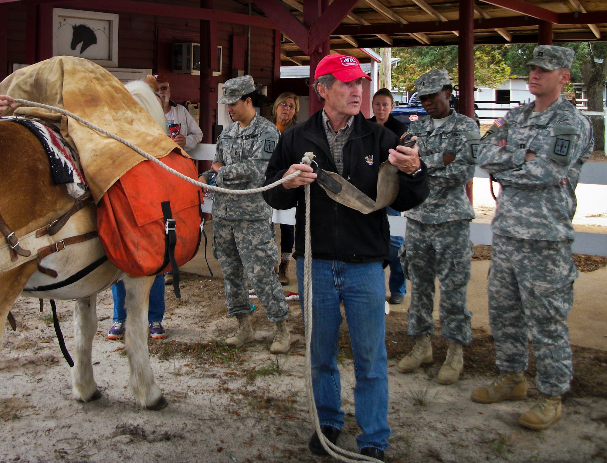 Charlie Brown instructs explosive ordnance disposal officers on how to pack equipment onto a horse during a training session in late 2013 at Eglin Air Force Base, Fla.  Eglin’s Sand and Spur Riding Club providing training on how to saddle, pack and ride horses to EOD Army officers as proactive exercise in case they were ever required to do so during a deployment.  (Courtesy photo)