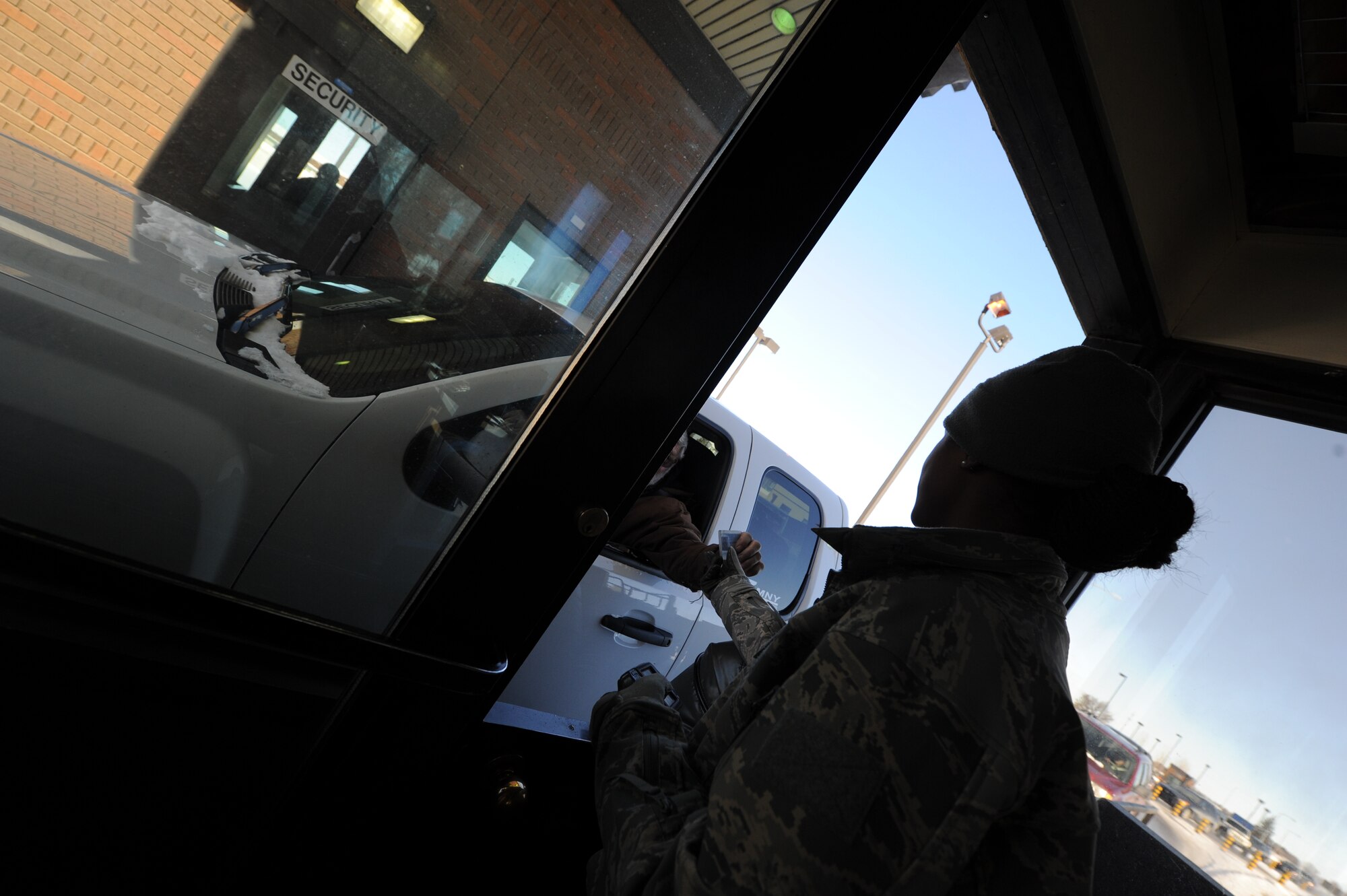 Vehicles wait in line at the Main Gate at Minot Air Force Base, Feb. 19, 2013. Airmen of the 5th Bomb Wing Safety Office are currently working on solutions to help minimize gate traffic. (U.S. Air Force photo/Senior Airman Brittany Y. Auld)