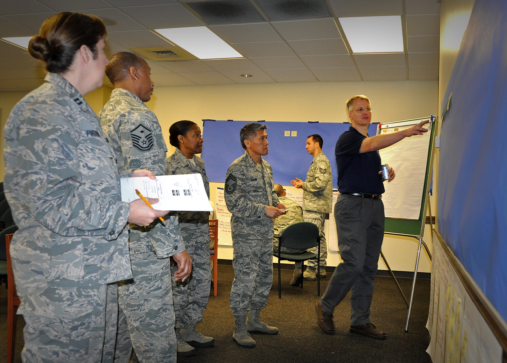 Matthew Arens, Air Force Reserve Command contractor Air Force Smart Operations for the 21st Century instructor, works with attendees during a week-long course at the 315th Airlift Wing at Joint Base Charleston. AFSO-21 is a dedicated effort to maximize value and minimize waste in its processes. The training’s objective is to establish a community of continuous process improvement that leverages the benefits of the collective experience, expertise, tools, and best practices. (U.S. Air Force Reserve photo by Michael Dukes)
