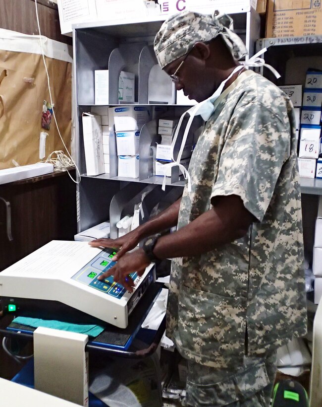 U.S. Army Staff Sgt. Paul Richards, Joint Task Force-Bravo Medical Element, works to correct malfunctioning equipment at the Puerto Cortest Area Hospital during a Medical Readiness Training Exercise in the Puerto Cortes region of Honduras, Feb. 19, 2014.  Joint Task Force-Bravo’s Mobile Surgical Team (MST) partnered with the Honduran surgical staff at the hospital to complete 12 surgeries and consult on 5 additional cases over three days.  (Photo by U.S. Army Sgt. Jennifer Shick)