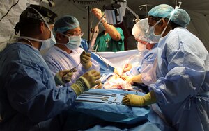 Members of Joint Task Force-Bravo's Mobile Surgical Team (MST) perform a surgical procedure during a Medical Readiness Training Exercise at Puerto Cortes Area Hospital in the Puerto Cortes region of Honduras, Feb. 19, 2014.  The MST partnered with the surgical staff at the hospital to complete 12 surgeries and consult on 5 additional cases over three days.  (Photo by U.S. Army Sgt. Jennifer Shick)
