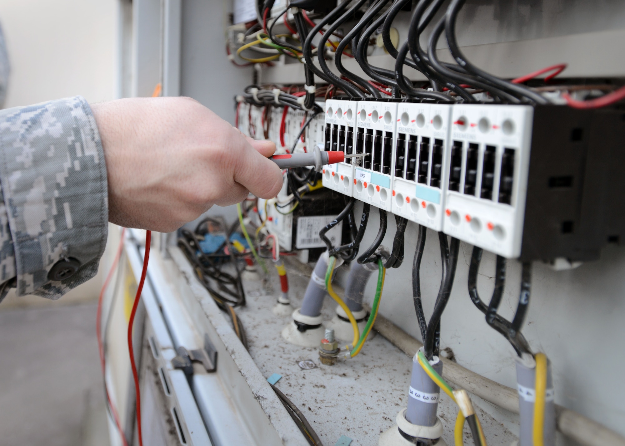 Senior Airman Matthew Ventresca, 31st Civil Engineer Squadron heating, ventilation, air conditioning and refrigeration technician, prepares to read an AC units circuit board. The board provides HVAC/R technicians the working status of AC units and any known warning signs or problems. (U.S. Air Force photo/Airman 1st Class Deana Heitzman)  