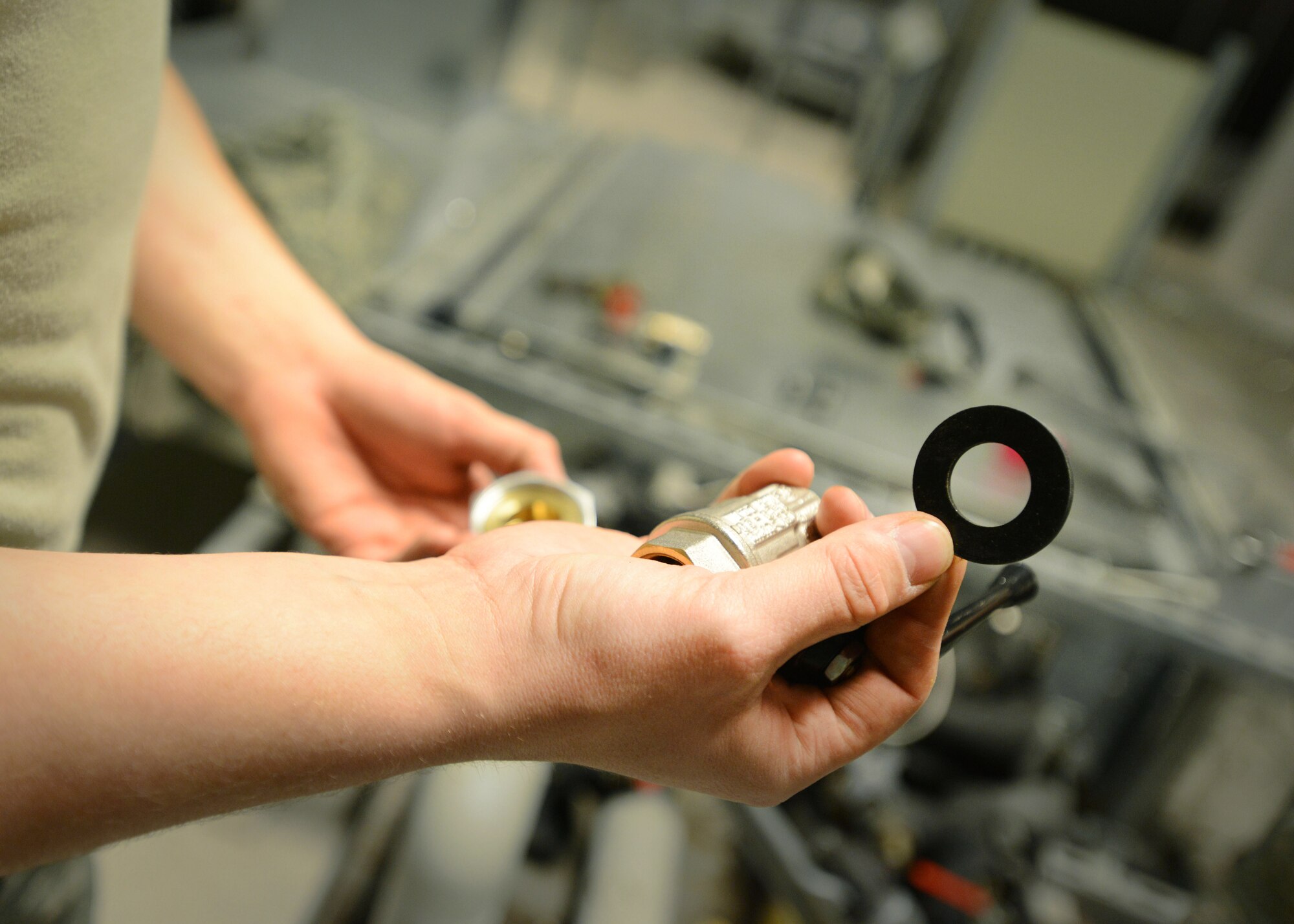 Senior Airman Michael Audet, 31st Civil Engineer Squadron heating, ventilation, air conditioning and refrigeration technician, prepares a ring for valve placement, Feb. 24, 2014, at Aviano Air Base, Italy. The HVAC/R team receives 20 to 30 work orders daily ranging from lack of hot water to rare emergency requests. (U.S. Air Force photo/Airman 1st Class Deana Heitzman)  