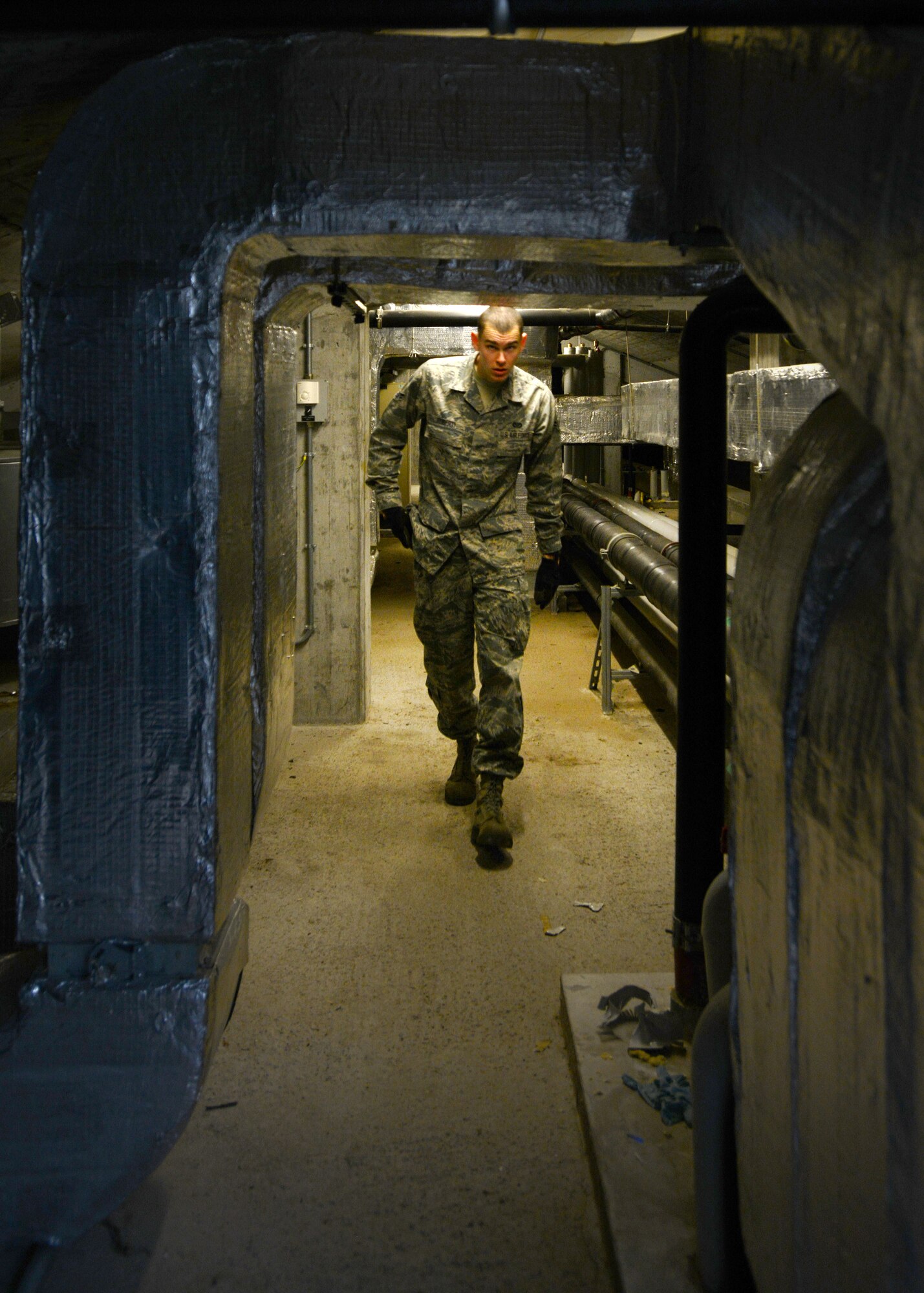 Airman 1st Class Bryan Ruberti, 31st Civil Engineer Squadron heating, ventilation, air conditioning and refrigeration technician, walks through the attic of a dormitory, Feb. 19, 2014, at Aviano Air Base, Italy. HVAC/R technicians contribute to a positive work atmosphere for Airmen by maintaining proper HVAC systems for more than 1,700 Aviano facilities.   (U.S. Air Force photo/Airman 1st Class Deana Heitzman)