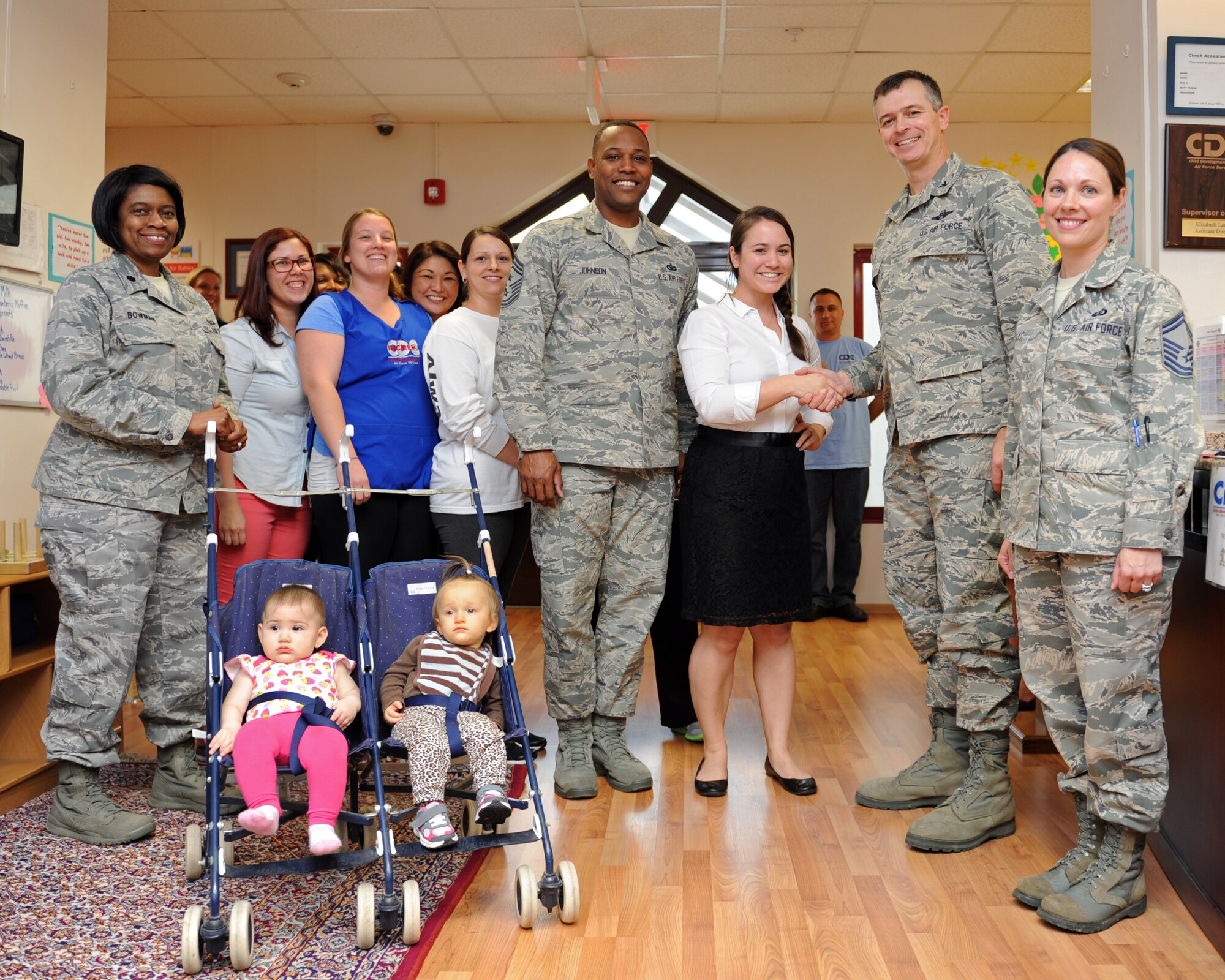 Elizabeth Larson (Center), 39th Force Support Squadron child development center assistant director, is awarded the "Pick of the 'Lik" for the week of Feb. 26, 2014, at Incirlik Air Base, Turkey. The 39th Air Base Wing leadership recognizes Airmen for demonstrating outstanding leadership and job performance abilities. (U.S. Air Force photo by Senior Airman Chase Hedrick/Released)