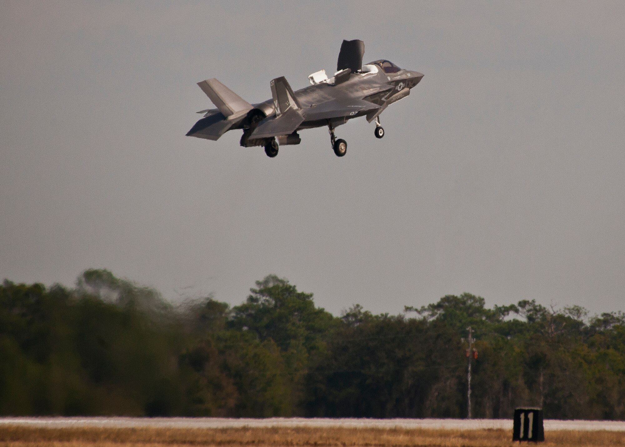 Royal Air Force pilot, Squadron Leader Hugh Nichols, lifts off in a Marine F-35B Lightning II for the first short take-off and vertical landing sortie by a United Kingdom pilot at Eglin Air Force Base, Fla., Feb. 25.  The U.S. Marines began flying STOVL sorties at Eglin in October 2013.  (U.S. Air Force photo/Samuel King Jr.)